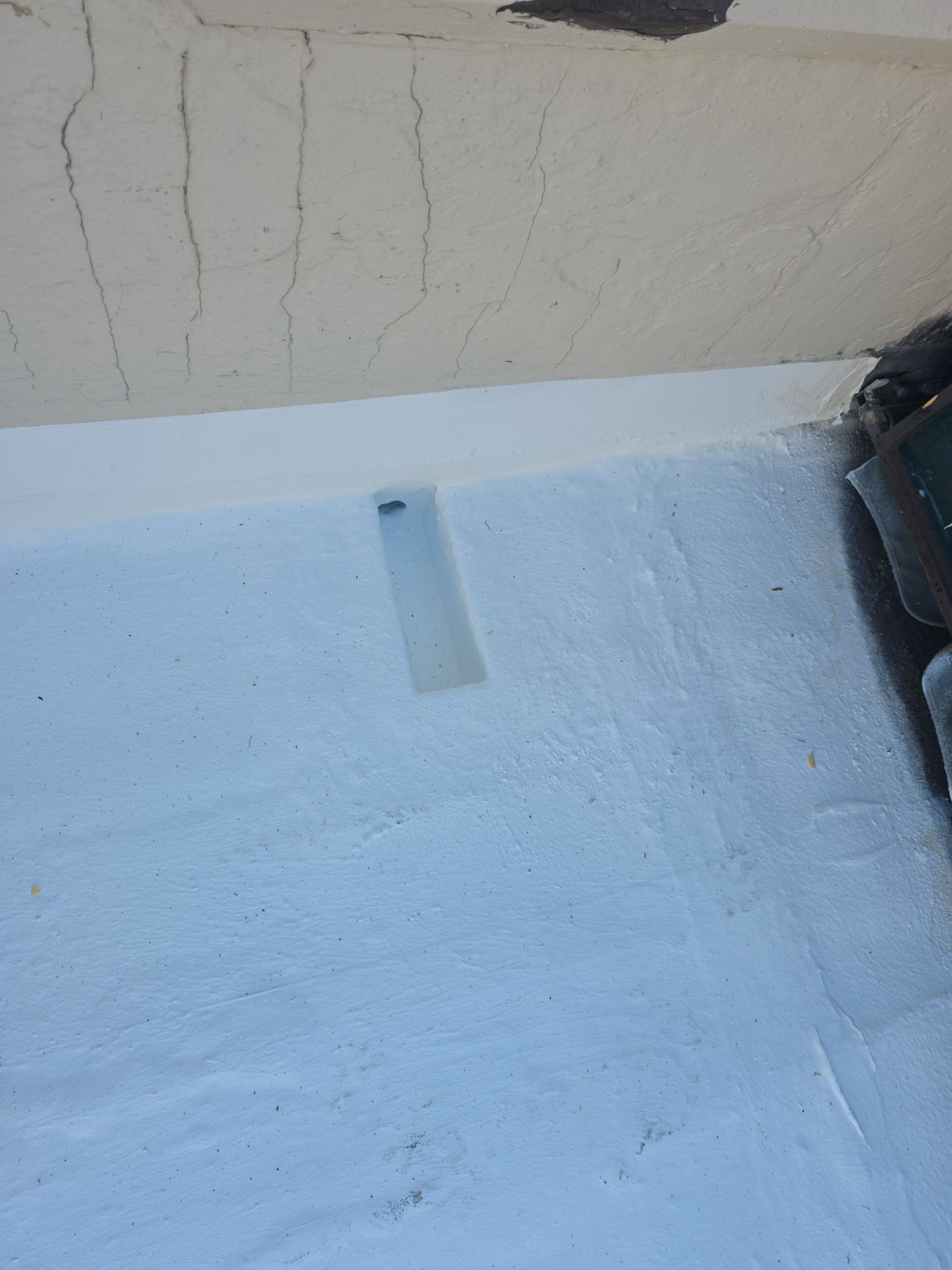 Foam and coatings on commercial roof by Straight Edge Roofing Inc
