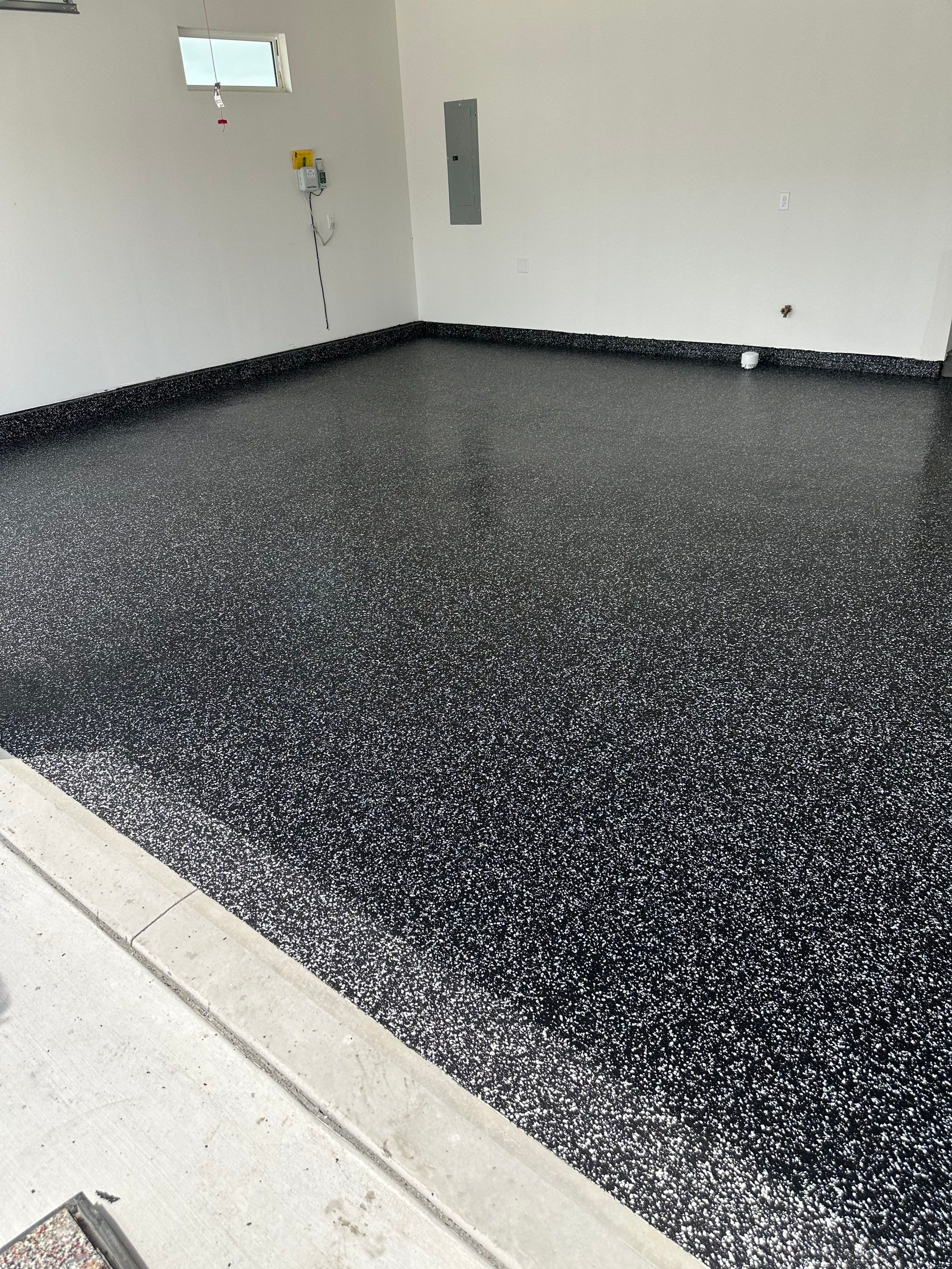 Black and White Speckled Epoxy Garage Floor in Lincoln by Goat Coatings