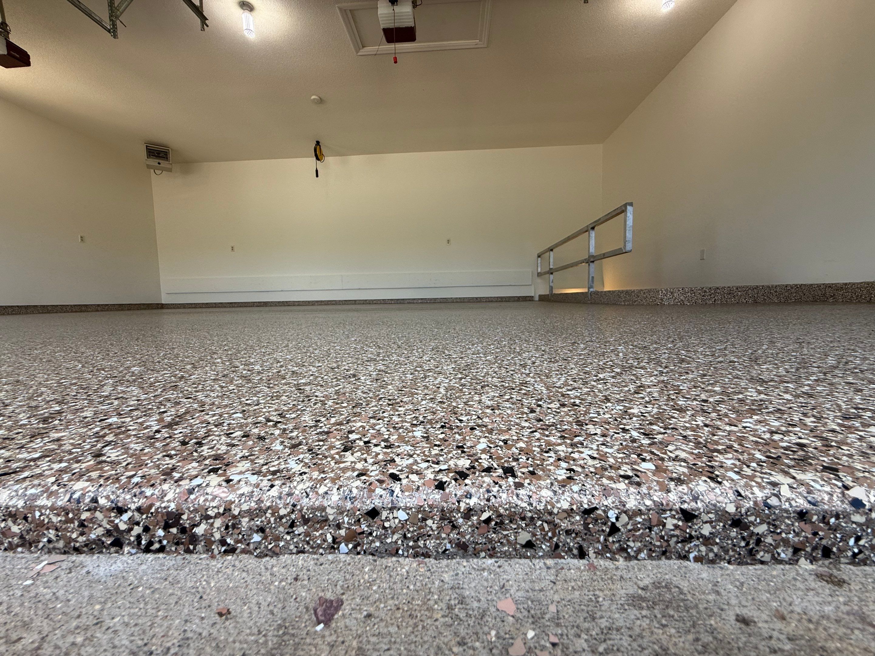Custom Polyaspartic Garage Floor and Stairwell Coating in Pipestone by Select Painting, Coatings & Garage Cabinets