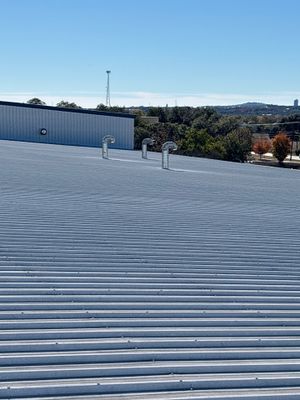 Wide shot of metal roof with multiple vents.