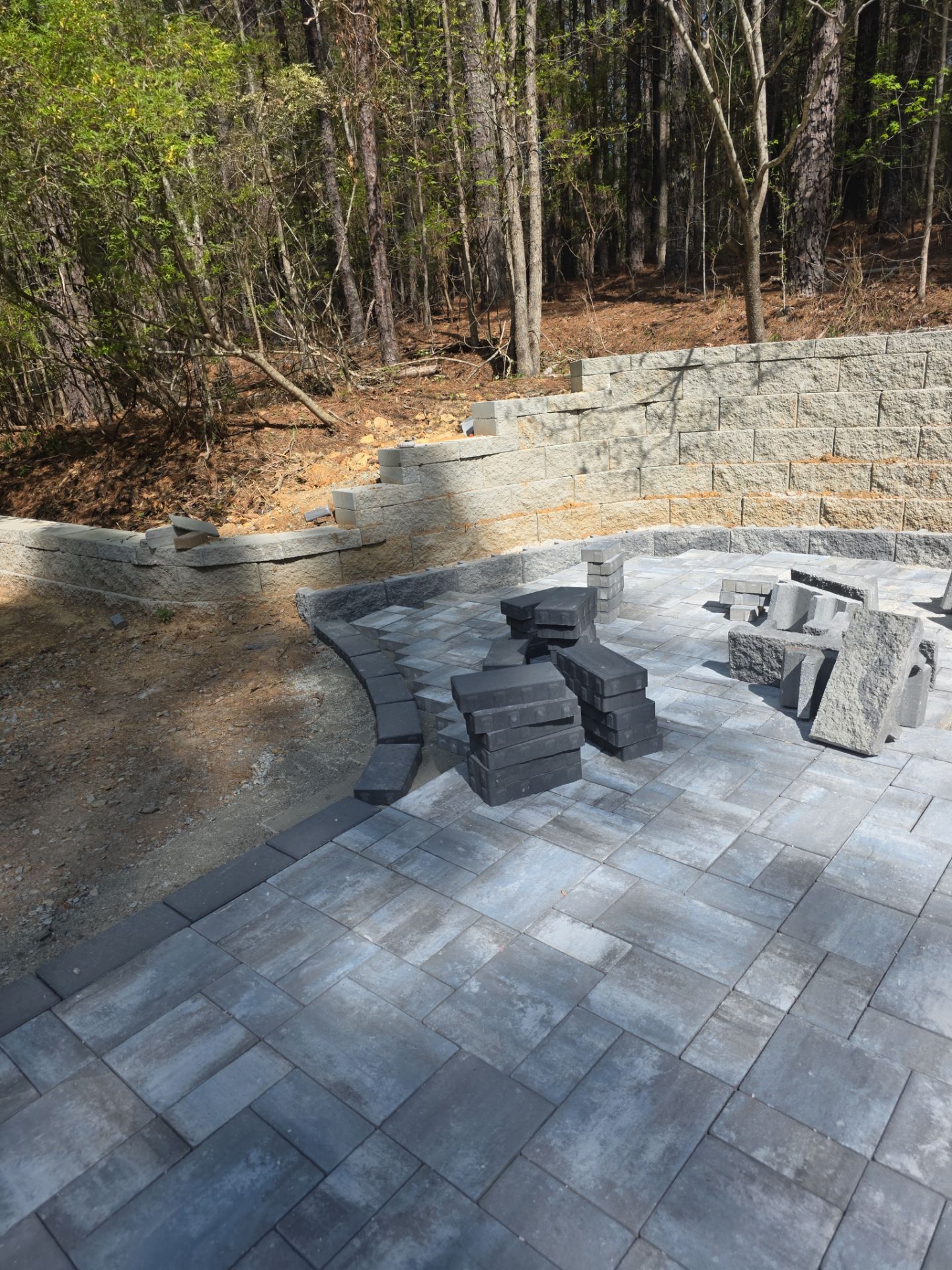 Pittsboro Outdoor Living Transformation – Retaining Wall, Paver Patio & Elevated Deck by Elite Remodeling and Design LLC