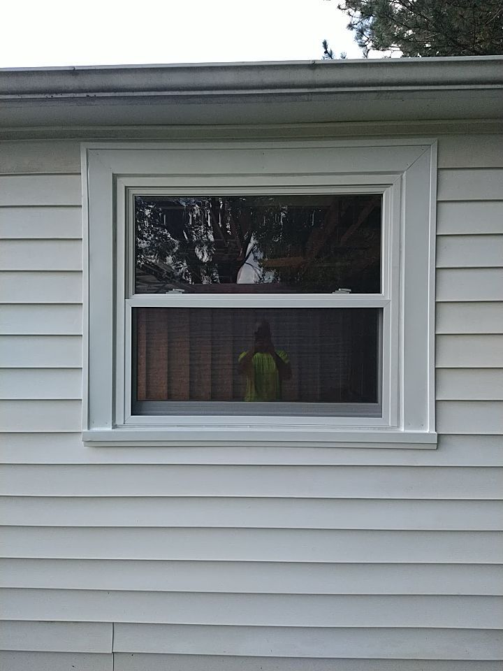Siding Installation using Norandex woodsman dl-5 white woodgrain vinyl by Absolute Roofing and Construction