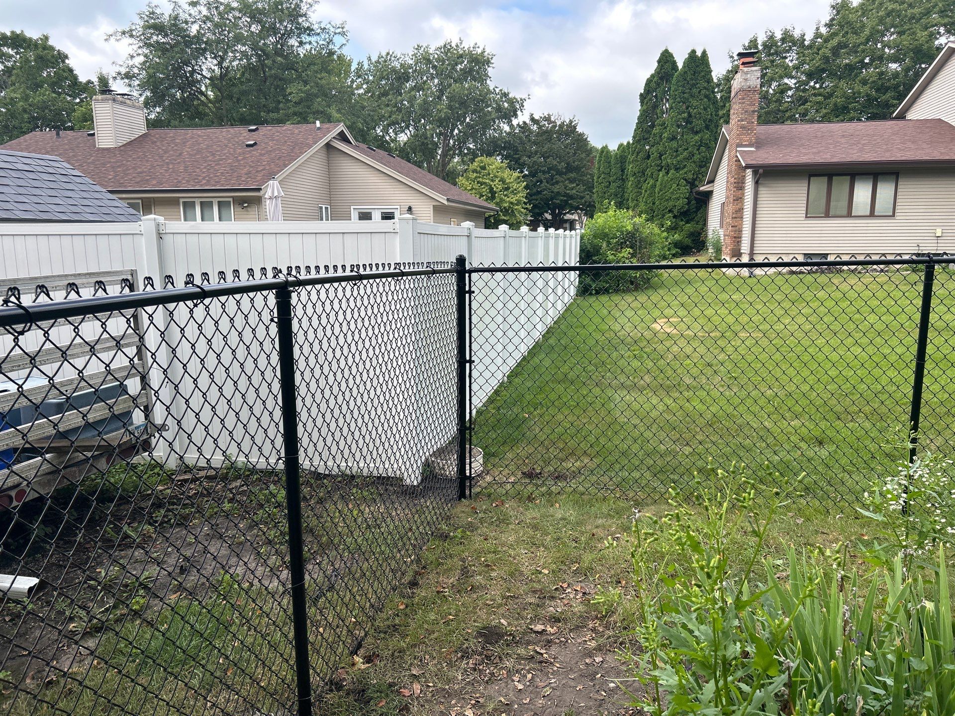 Black Vinyl Coated Chain Link Fence Installation in Waterloo by Perfect Picket Fence and Stain
