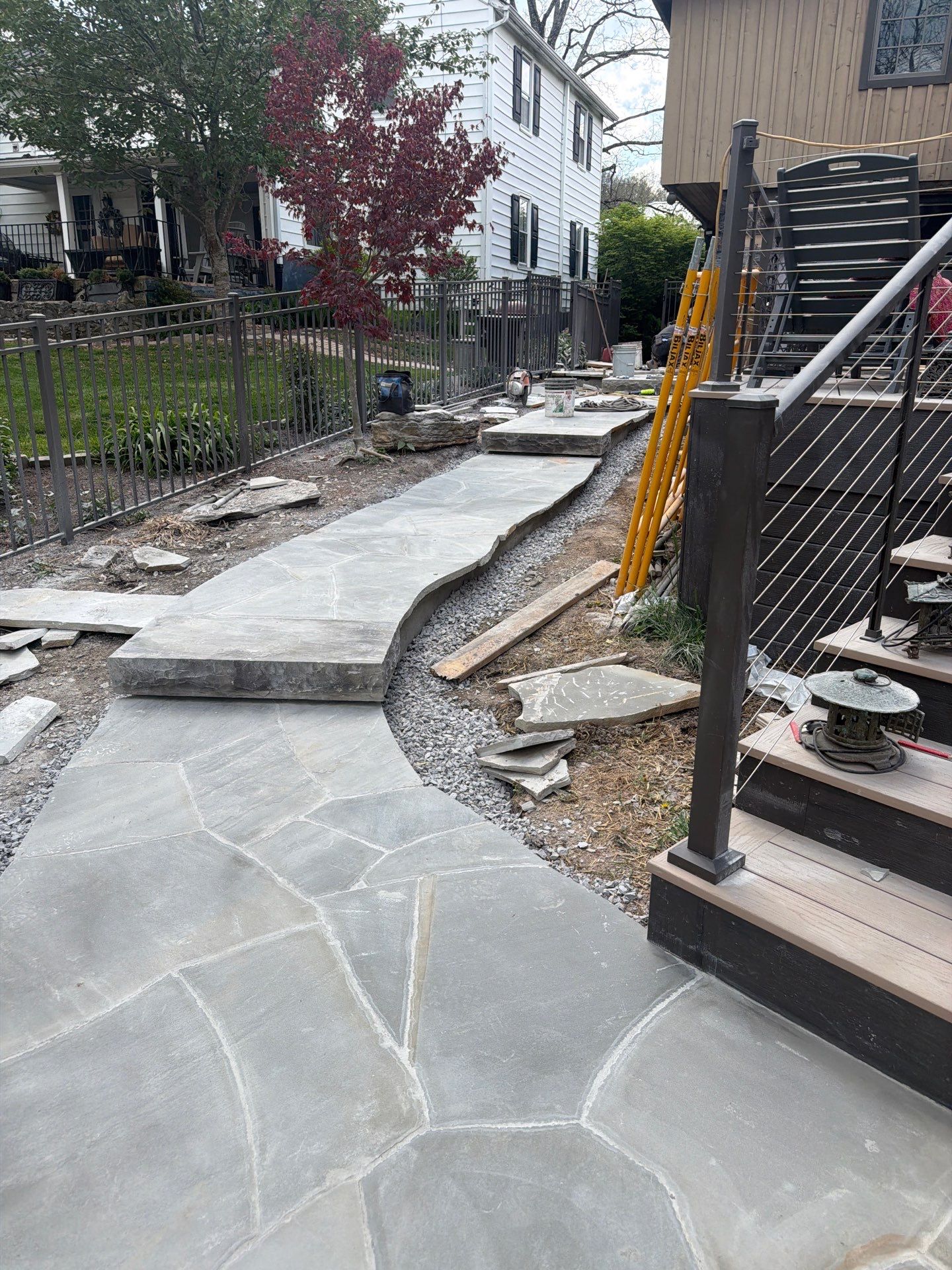 Custom Composite Deck with Stone Fireplace and Modern Cable Railing by Walnut Hollow Decks & Outdoor Living