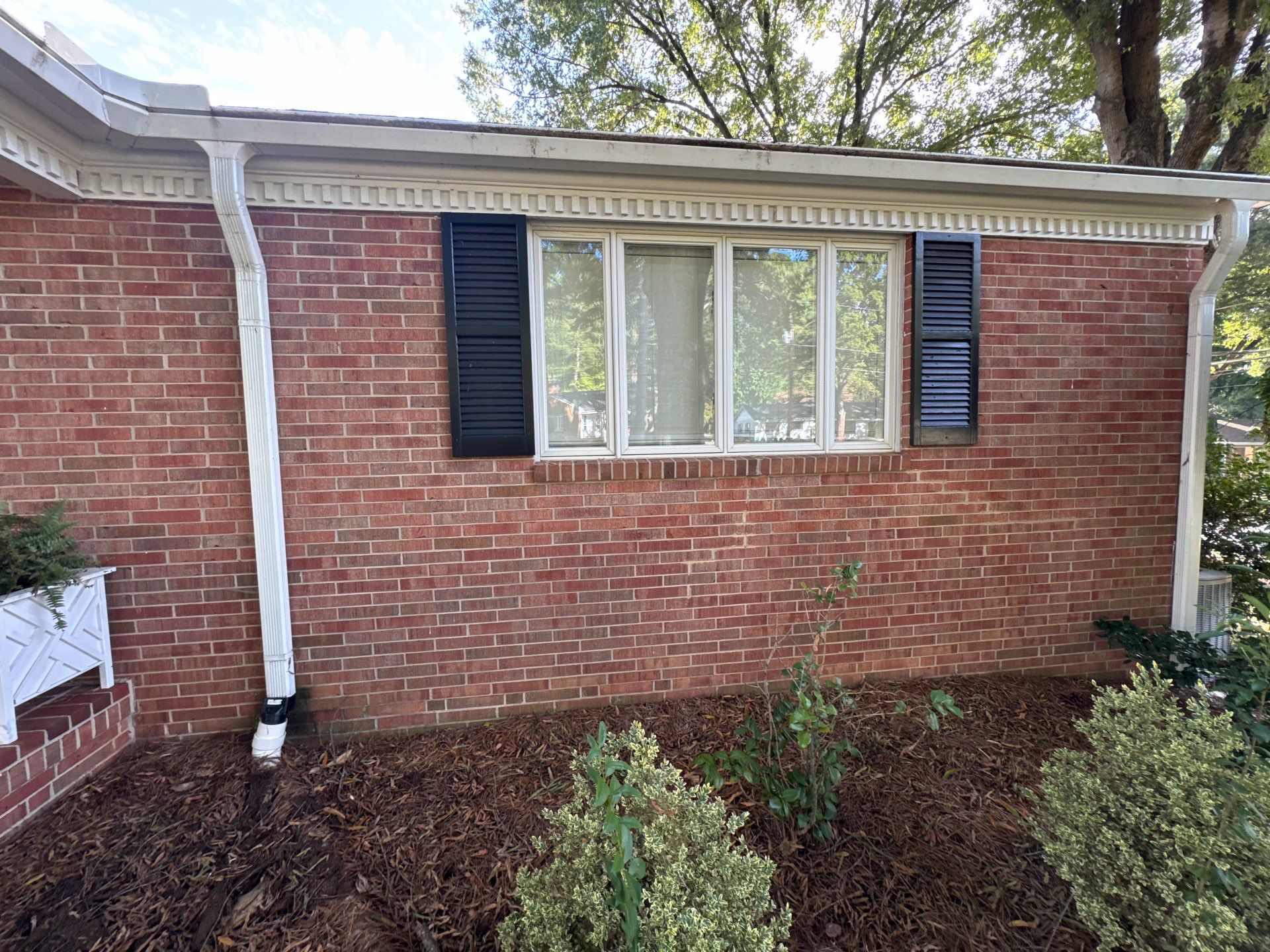 the service being done is cleaning the brick surface and gutters of the house to remove dirt and debris