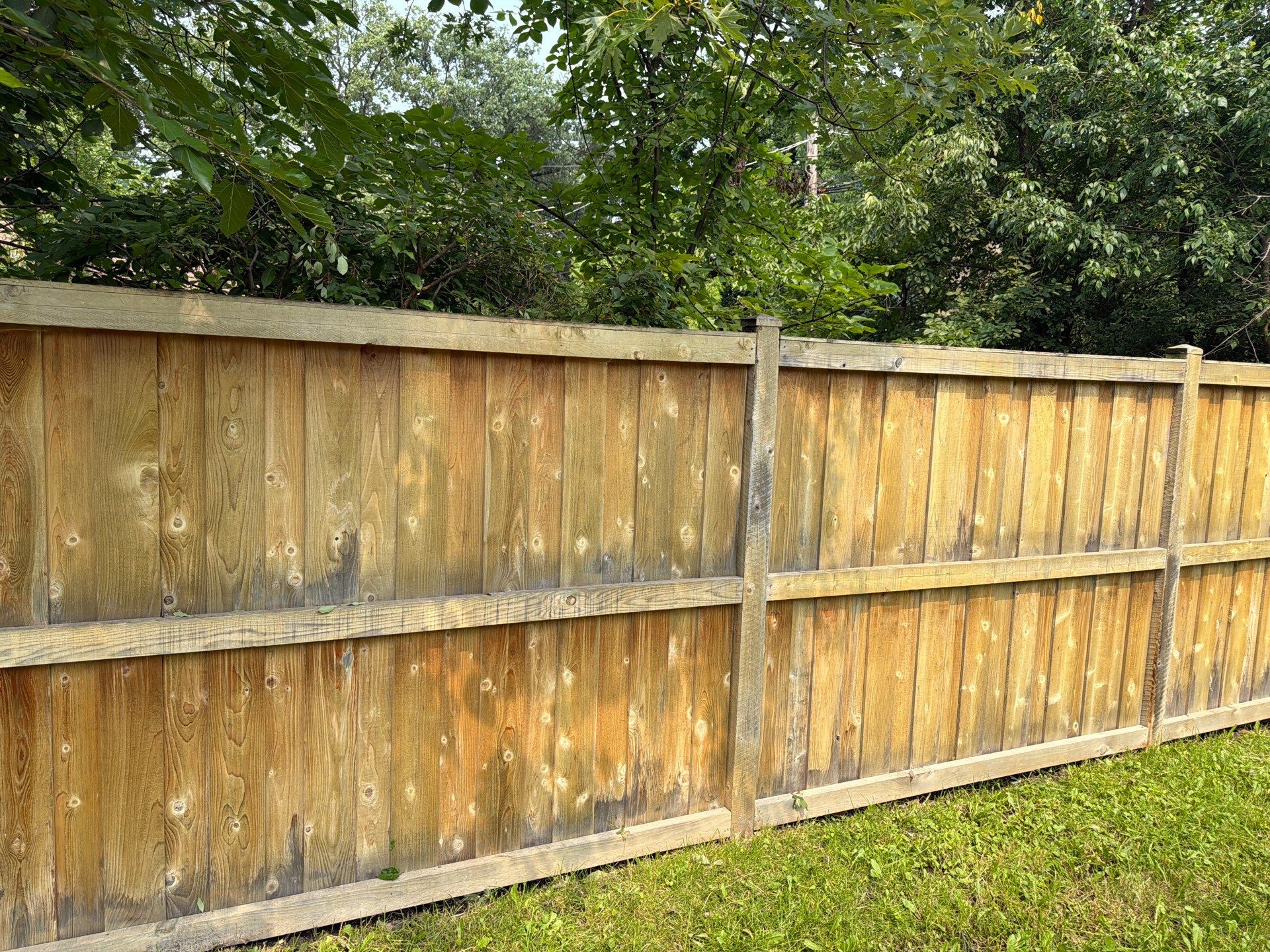 Wood fence cleaning and sealing by Northern Power Washing LLC.