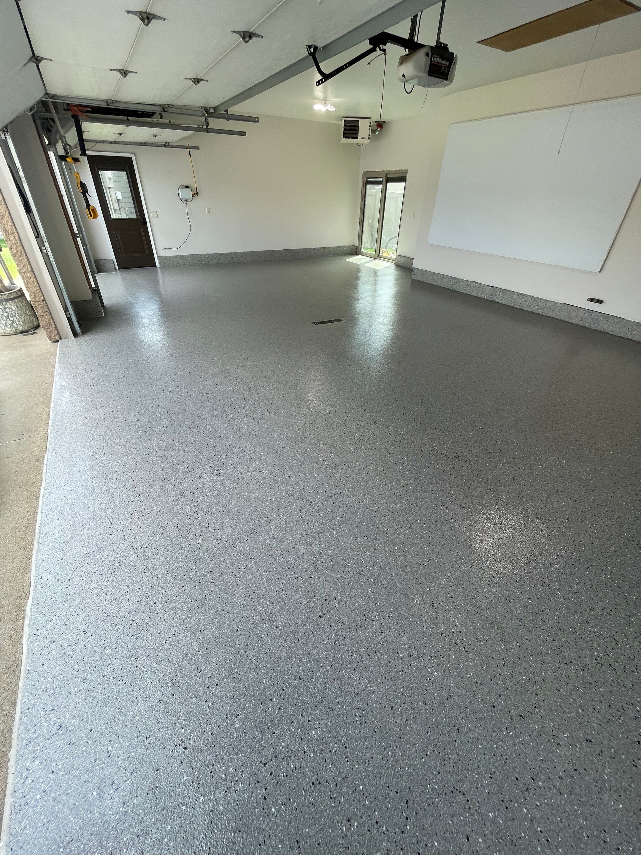 Residential Garage Floor Coating with Grey Speckled Epoxy Finish by Select Painting, Coatings & Garage Cabinets