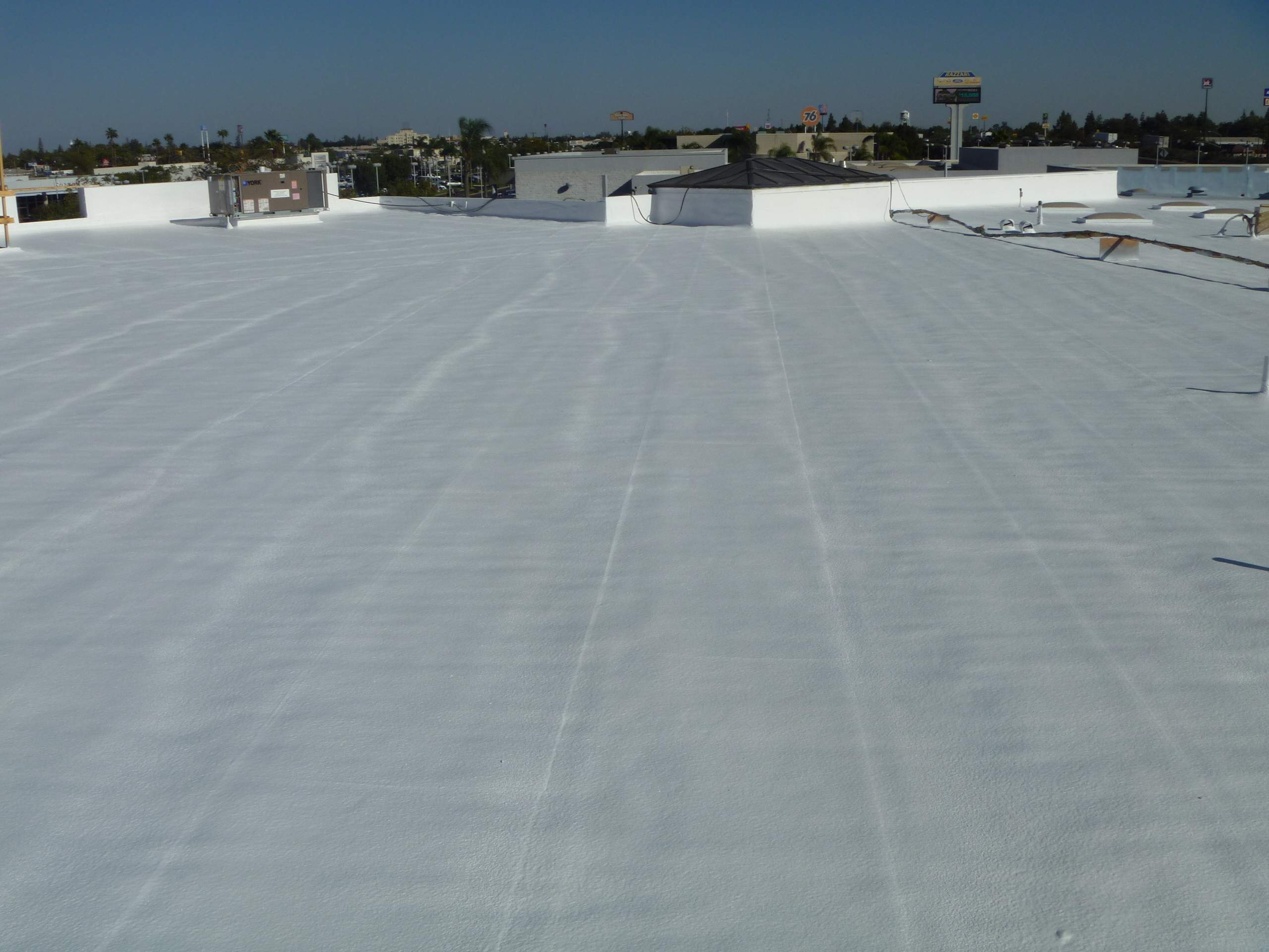 Commercial Roofing Installation using Spray foam and Conklin Benchmark/PUMA XL 18 yr warranty coatings by Straight Edge Roofing Inc