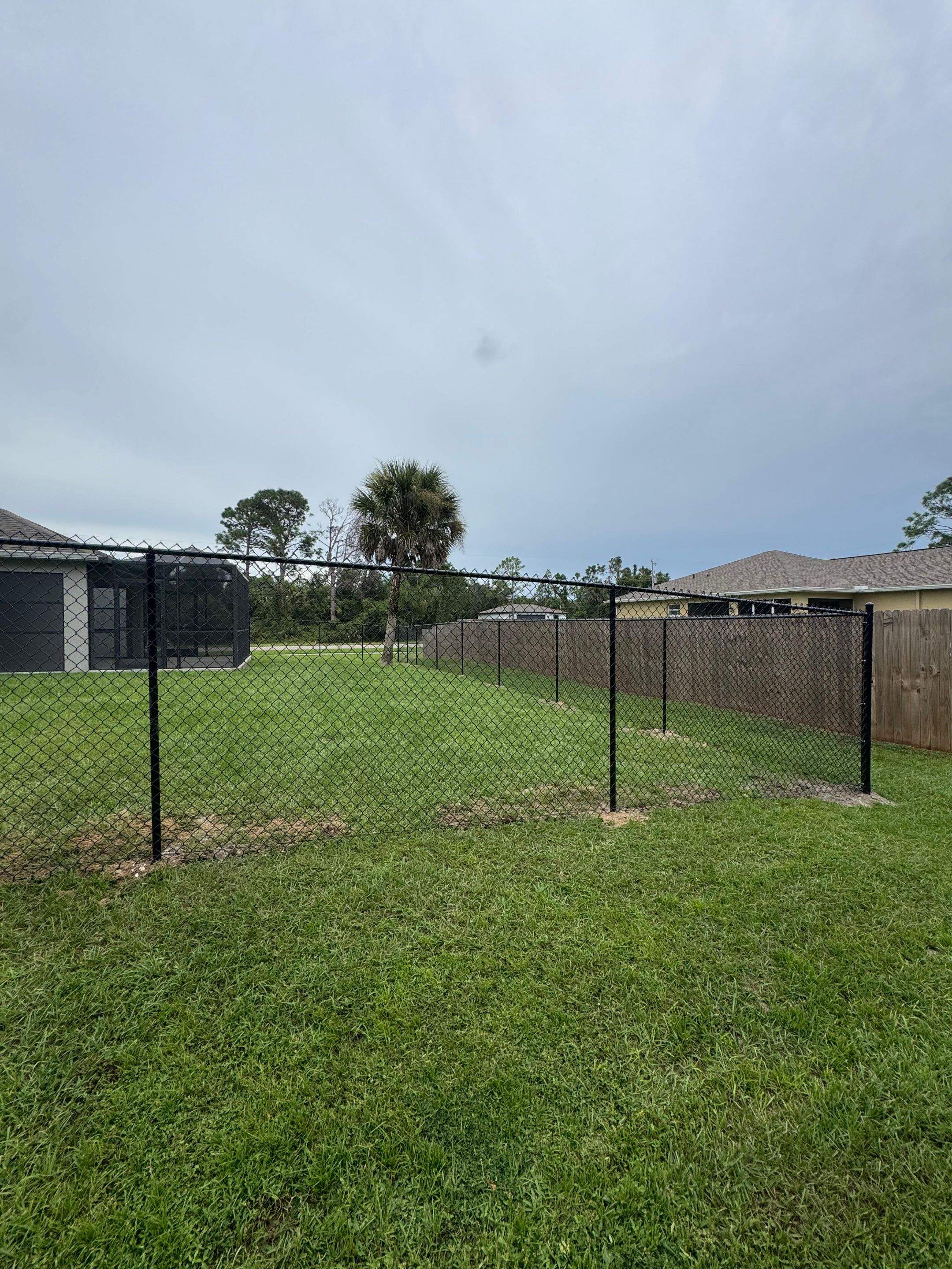 Black Chain Link Boundary Fence with Access Gates in North Port by True Fence LLC
