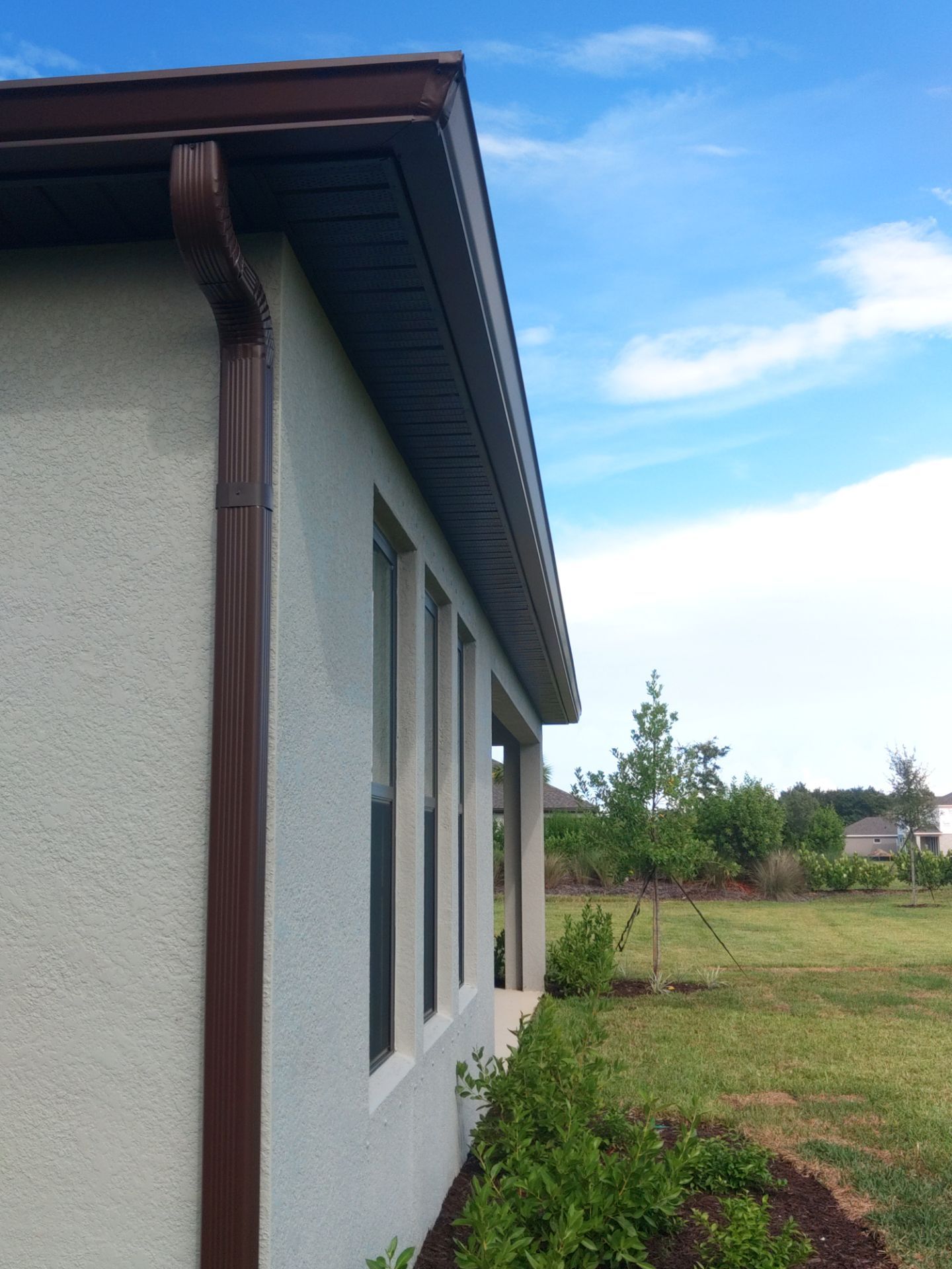 Musket Brown Seamless Gutters using Musket Brown Seamless Gutters in Nokomis FL by Gutter Professors