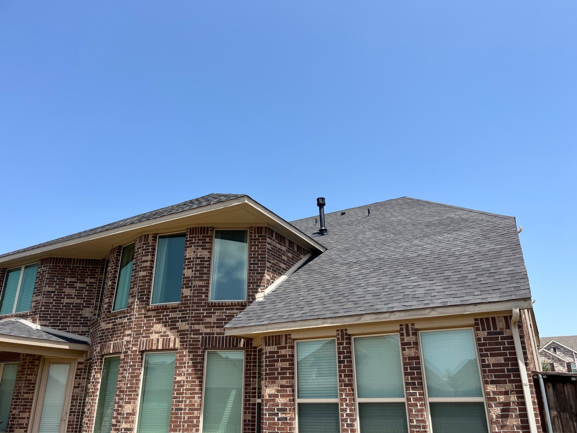 IKO Glacier-Brown Brick house by Tejas Roofworks + Restoration