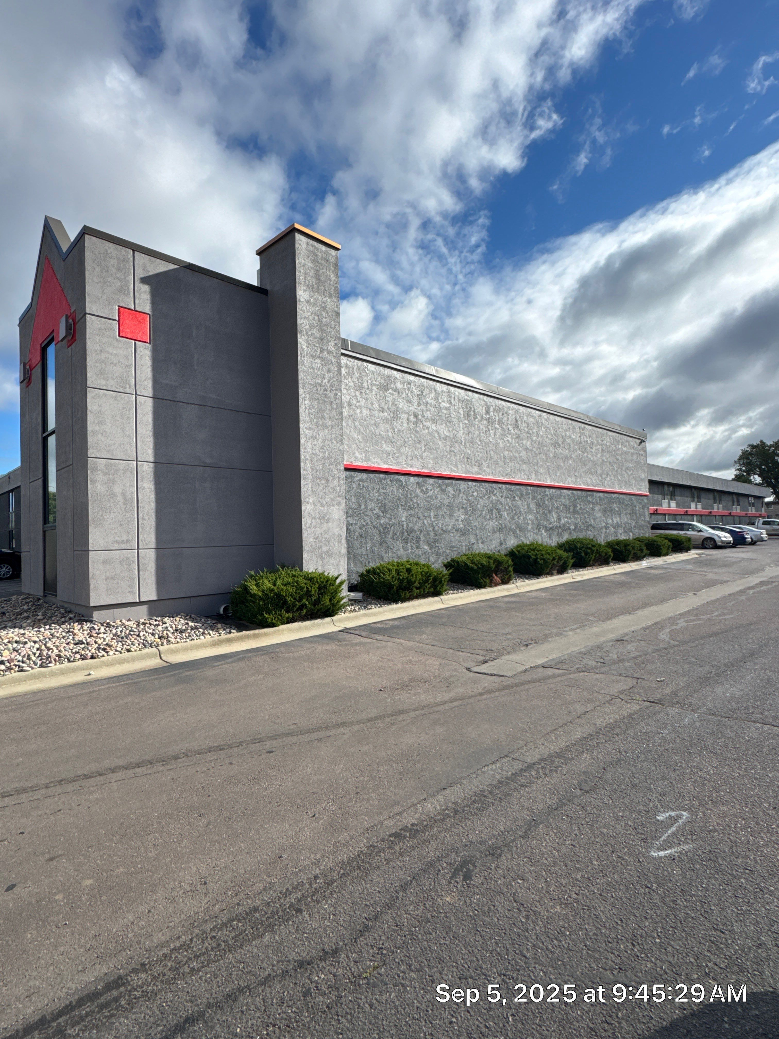 Commercial Exterior Painting with Stucco and Bold Red Accent Trim by Select Painting, Coatings & Garage Cabinets