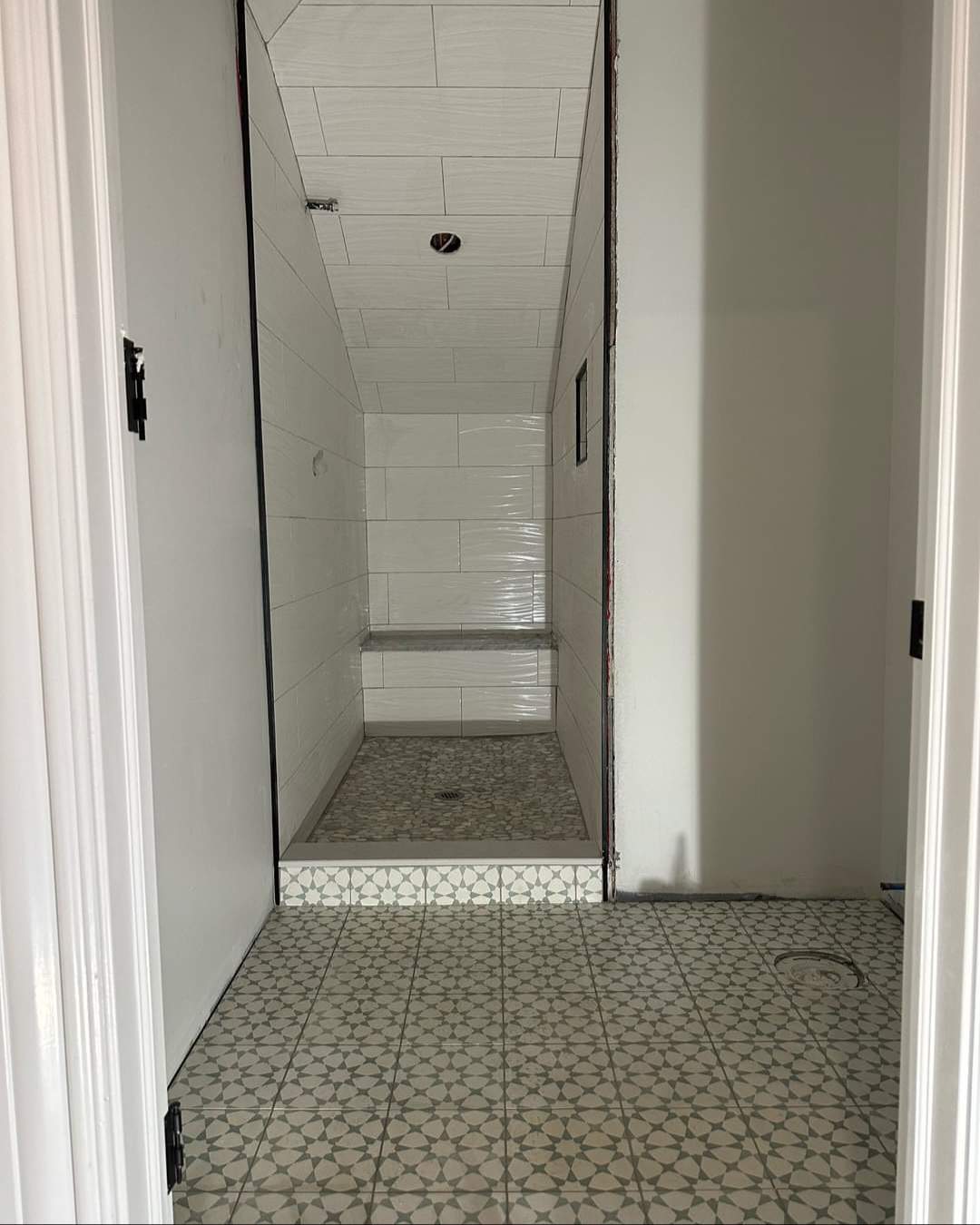 Kids Bathroom Shower using Large Porceline Subway Tile + Mosaic Floor Tile by Footprints Floors Morristown