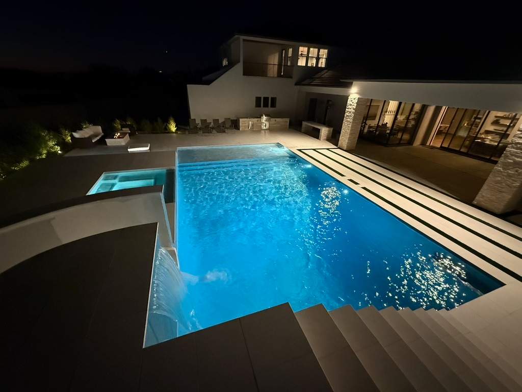 Pool and spa build with slide & outdoor kitchen by Modern Pools