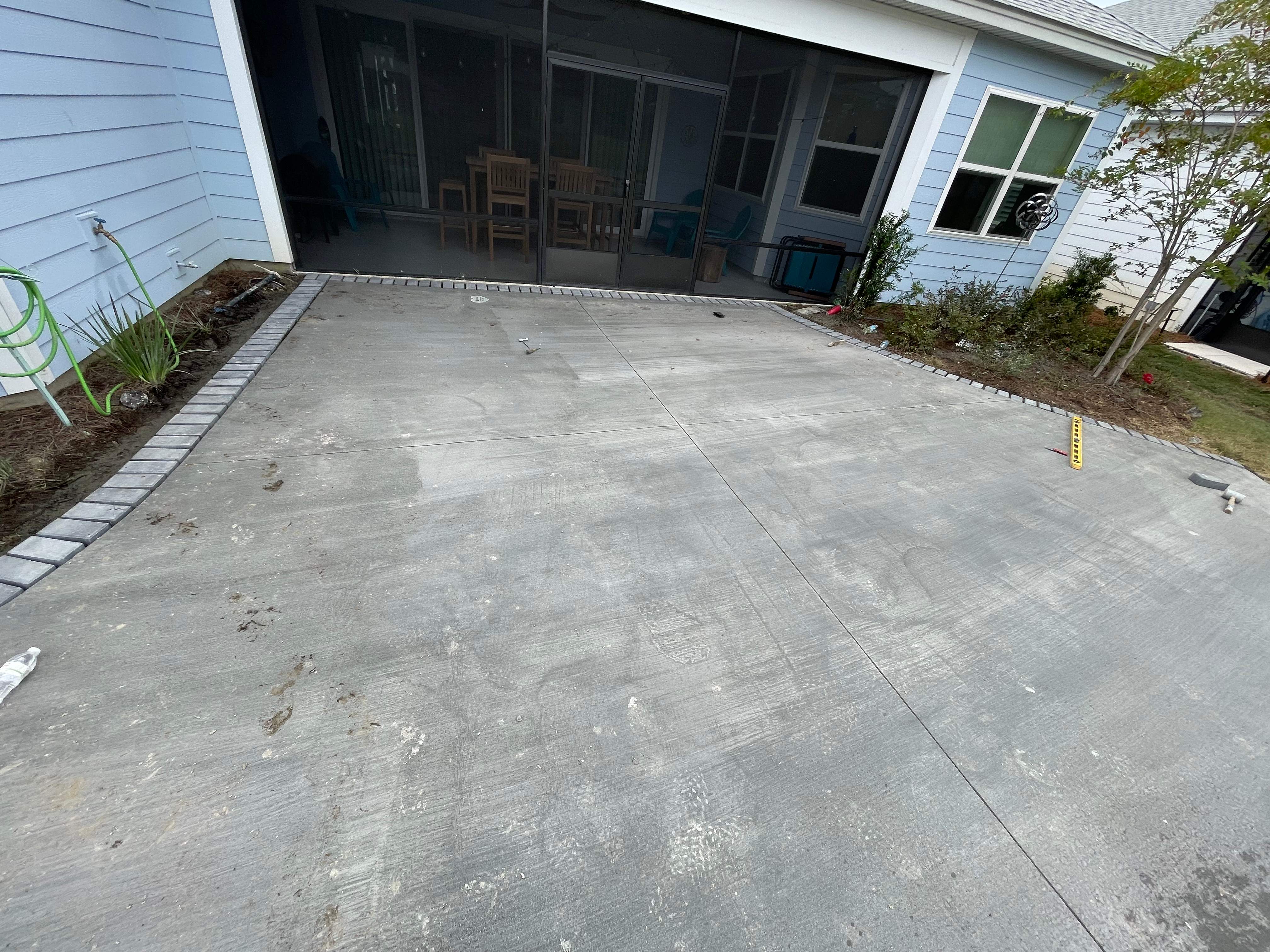 Custom Curved Concrete Patio and Paver Border in Hardeeville by Lowcountry Scapes, LLC