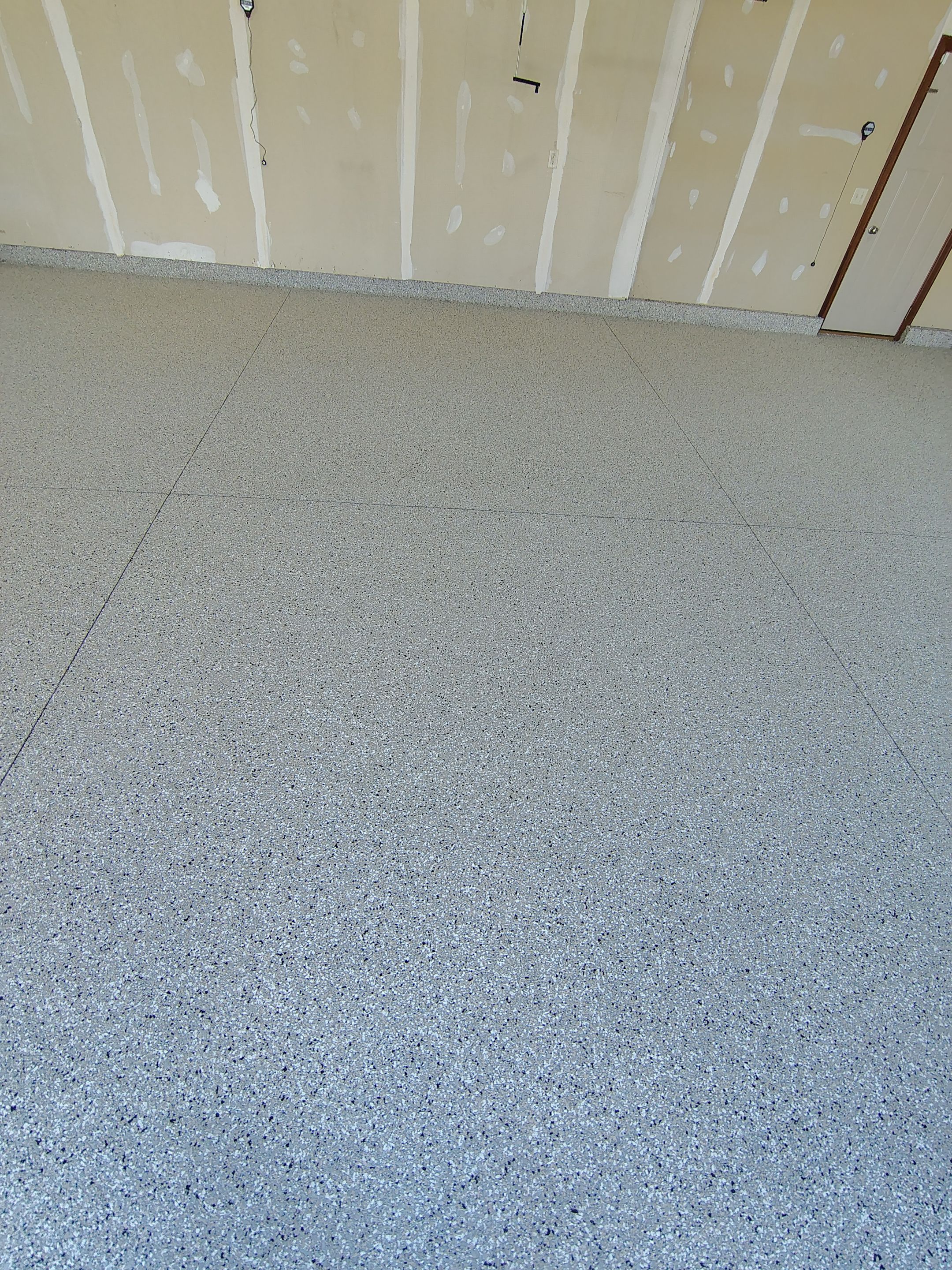 Multi-Car Garage Concrete Coating and Epoxy Finish in Sioux Falls by Select Painting, Coatings & Garage Cabinets