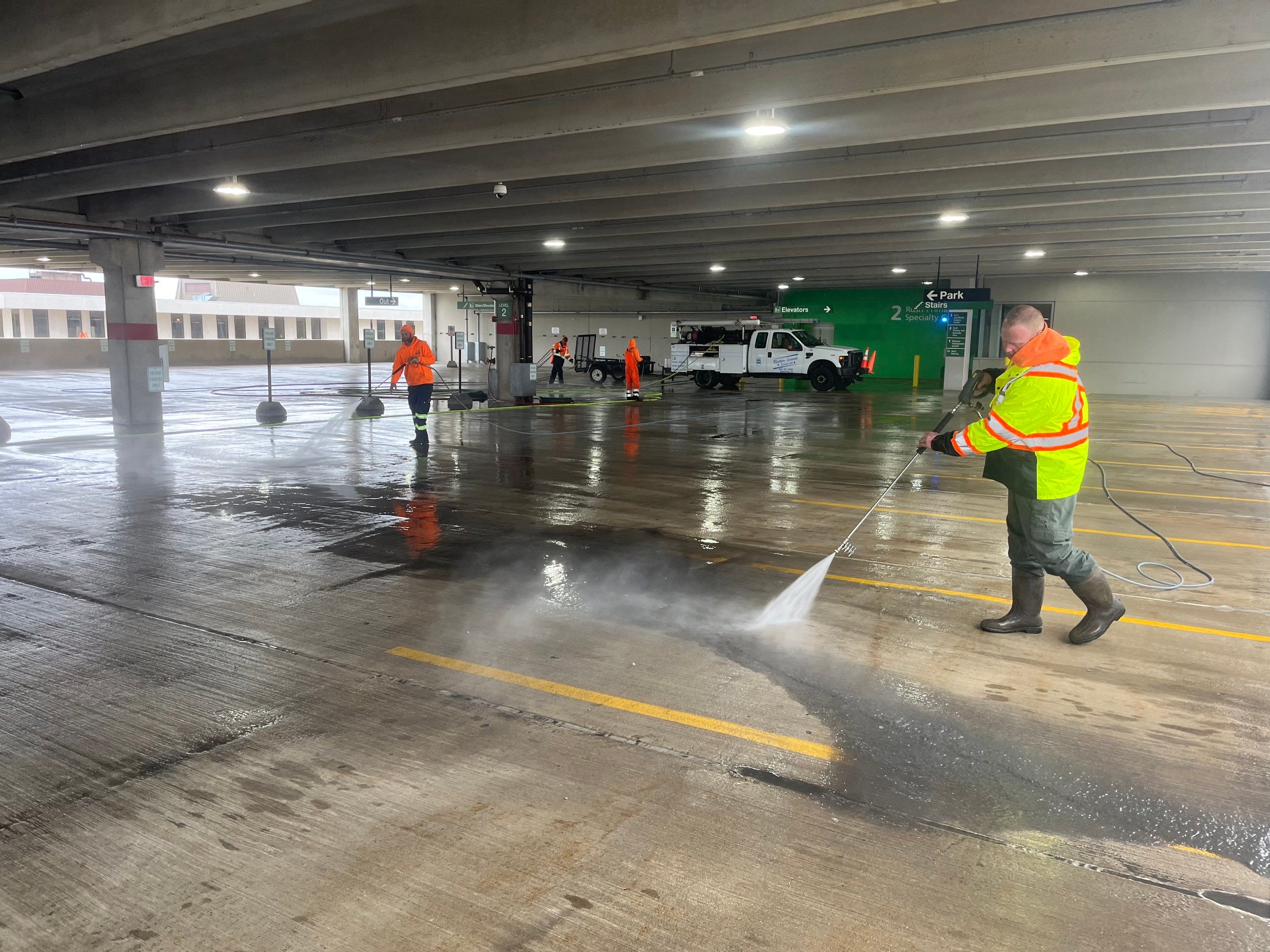Parking garage using Hot water by Northern Power Washing LLC.