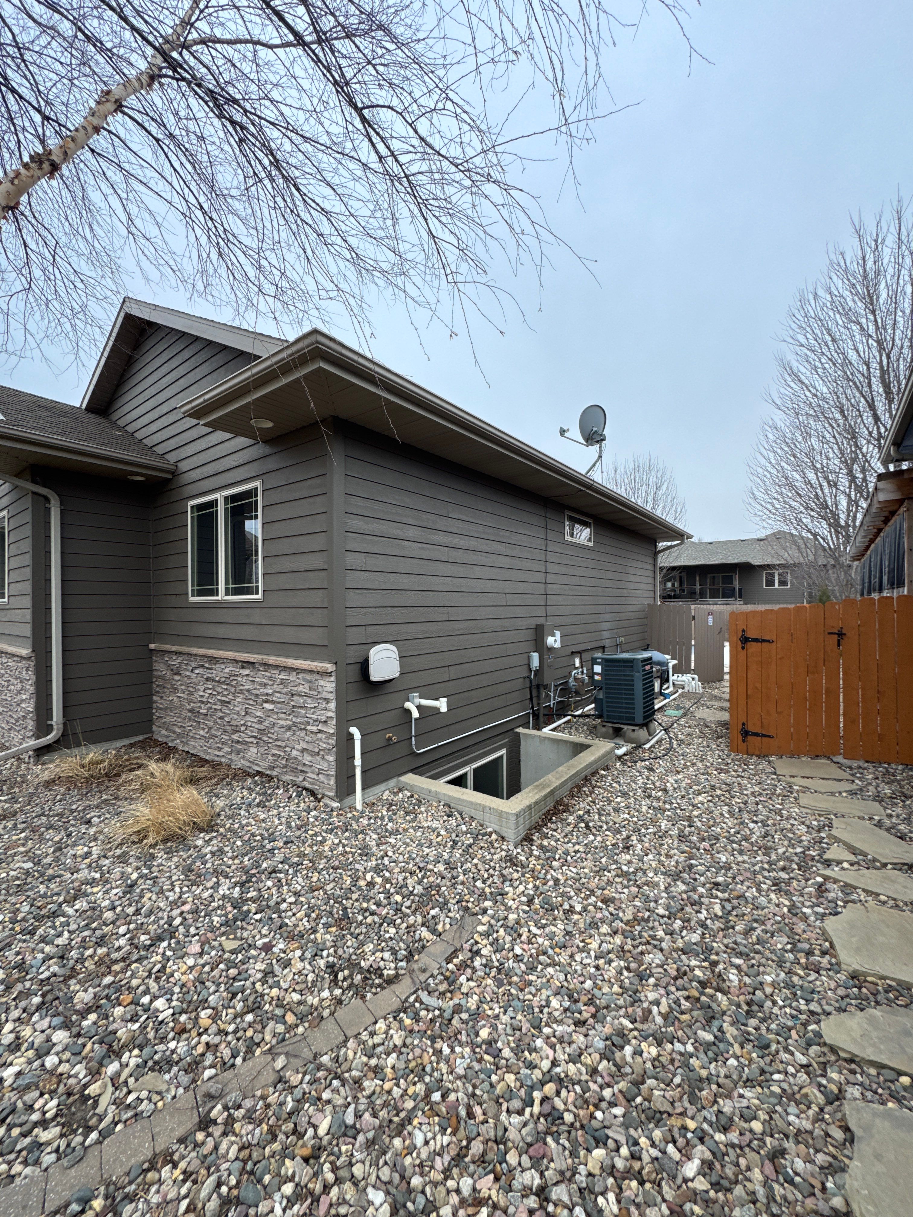 Sioux Falls Residential Exterior Update and Flagstone Pool Deck by Select Painting, Coatings & Garage Cabinets