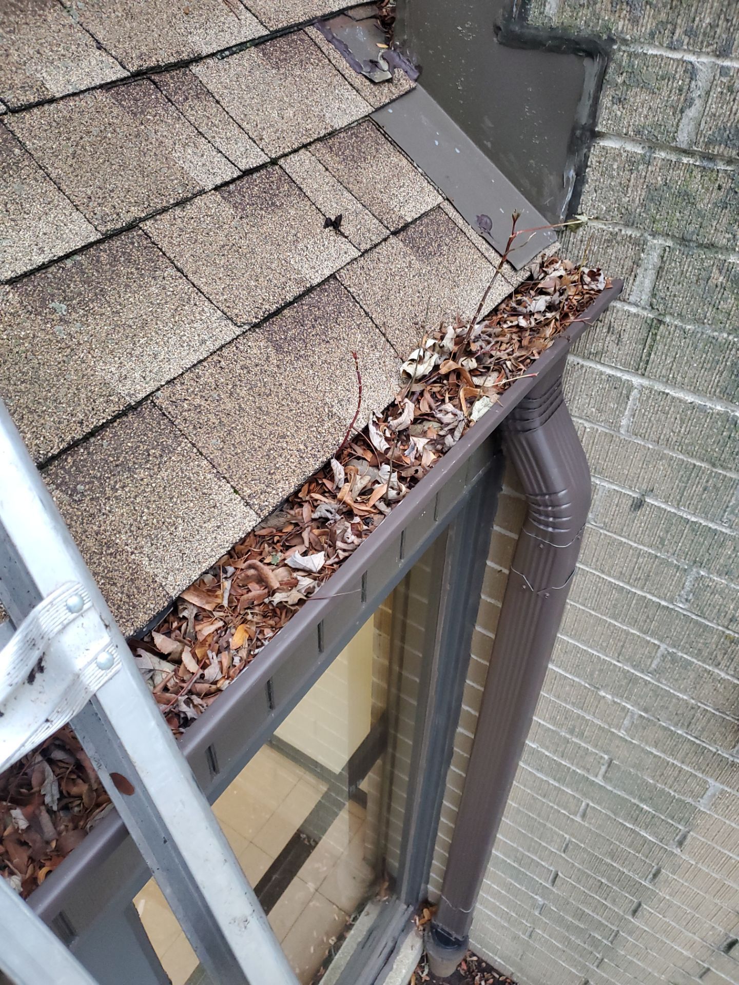 Commercial gutter cleaning West Allis, WI before photo with filled gutters