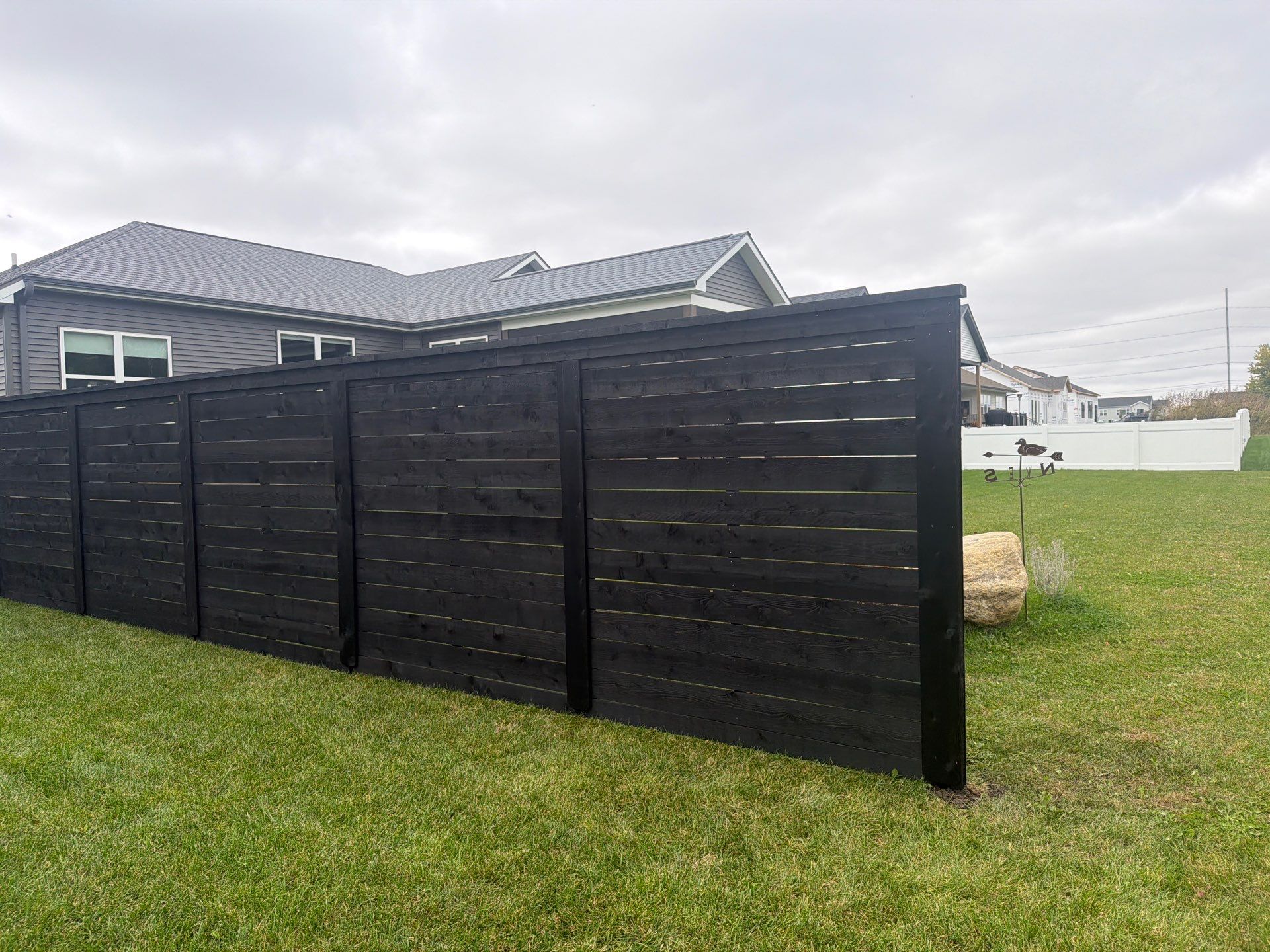 Modern Horizontal Wood Privacy Fence Installation in Cedar Falls by Perfect Picket Fence and Stain