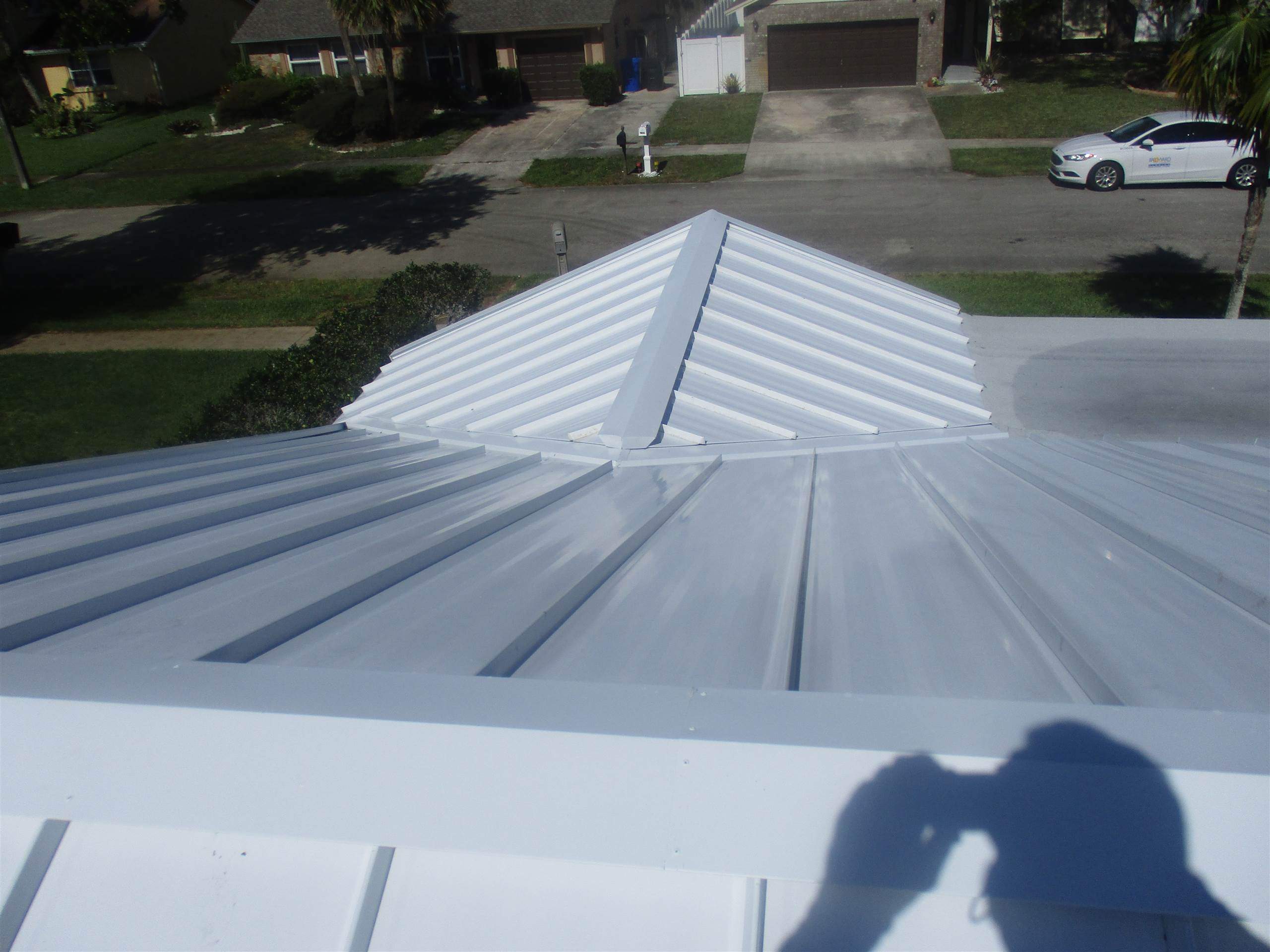 Standing Seam Metal & Flat Re-Roof using 1.5" Nail Strip 24ga Solar White Kynar Coated Standing Seam Metal Panels by Morton Roofing, Inc.