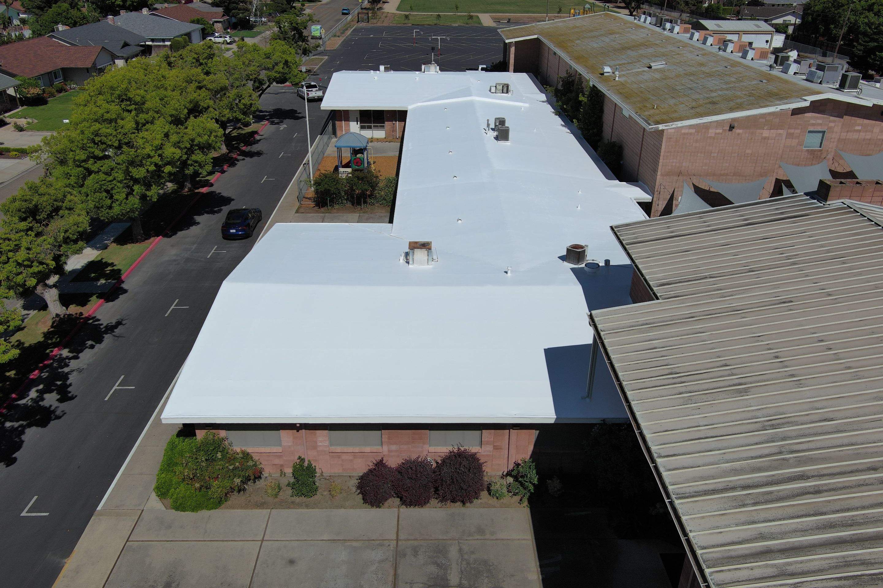 Single-ply restoration system using Benchmark/PUMA XL coatings over TPO single-ply roofing by Straight Edge Roofing Inc