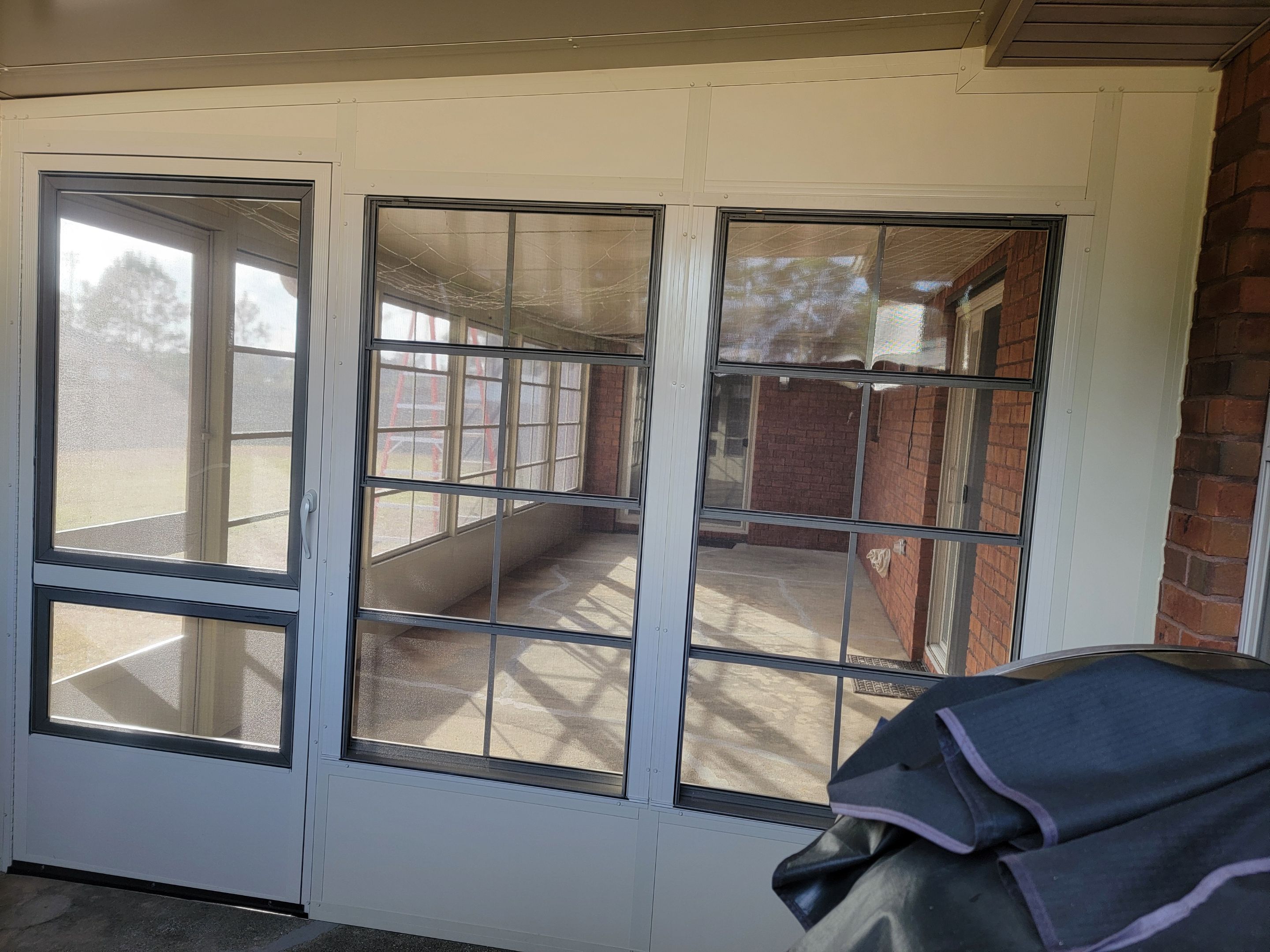 Enclosure w/Vinyl Windows using Colorbeam by Titan Sunrooms