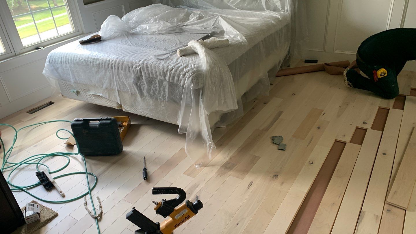 Flooring Installation using Maple Hardwood by Greenspring Construction Services