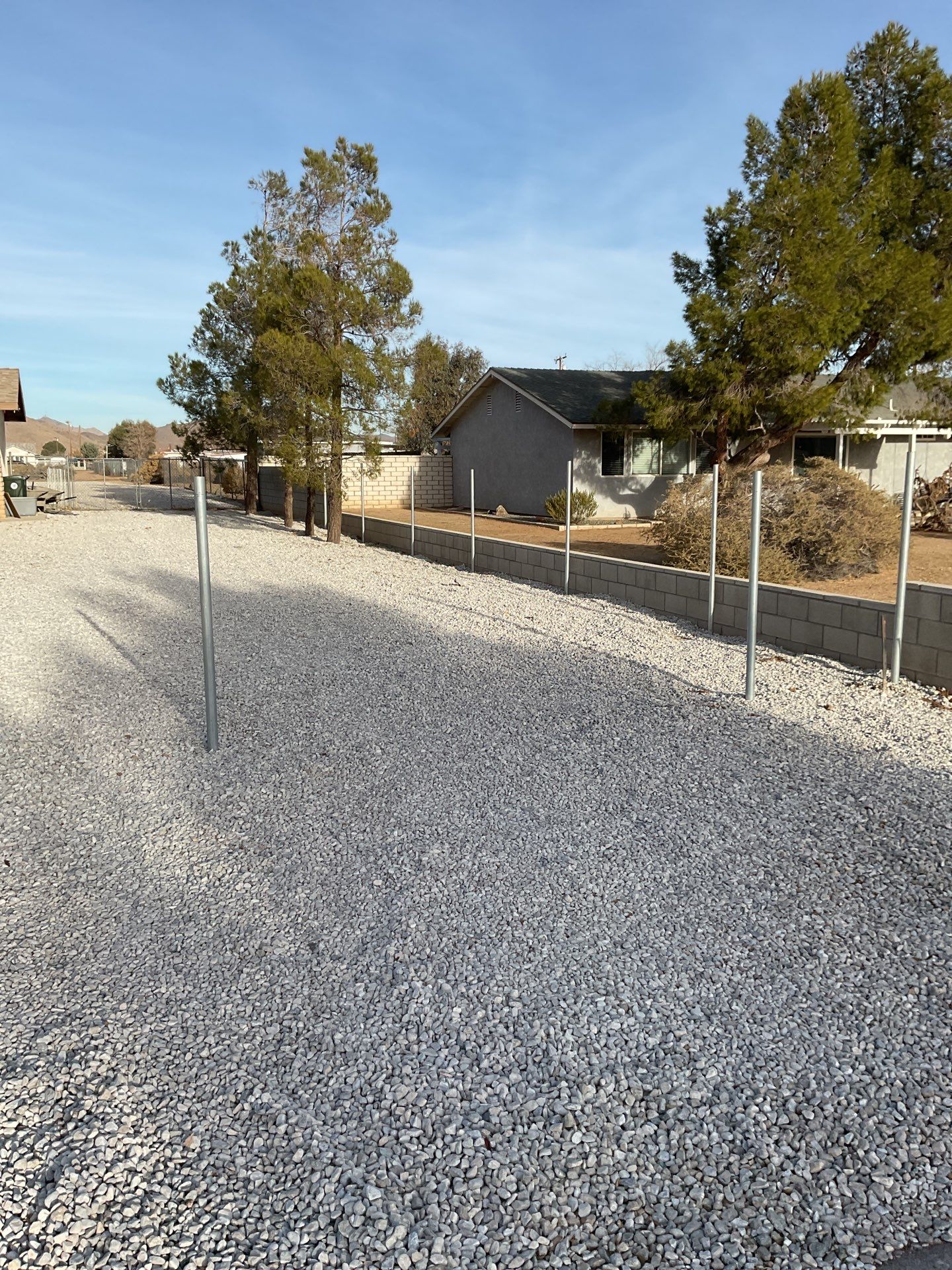 Sleek chain link fence installation with a solar motorized gate by Fence Guys Inc.