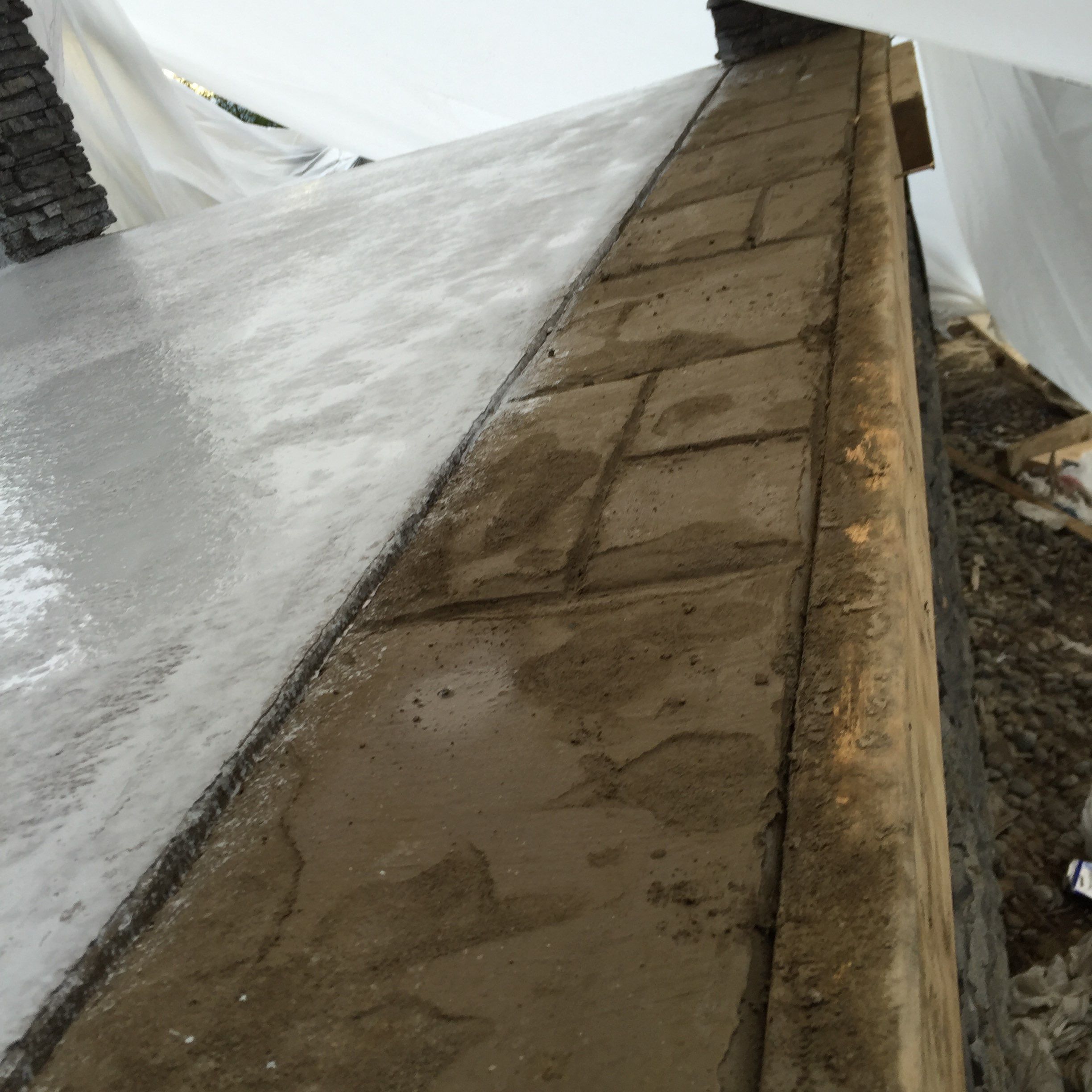 Asphalt Driveway and Stamped Concrete Patio Finish  by Jireh Asphalt & Concrete Inc 