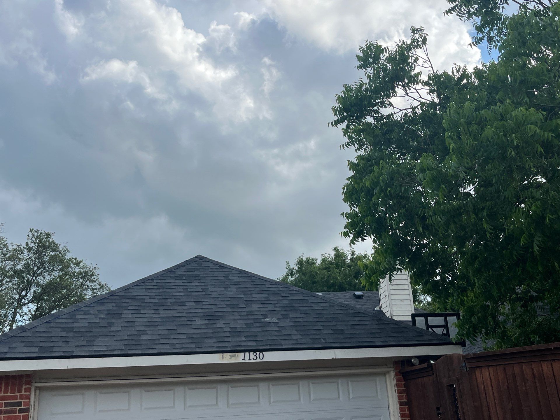 Red brick with Malarkey Midnight Black  by Tejas Roofworks + Restoration