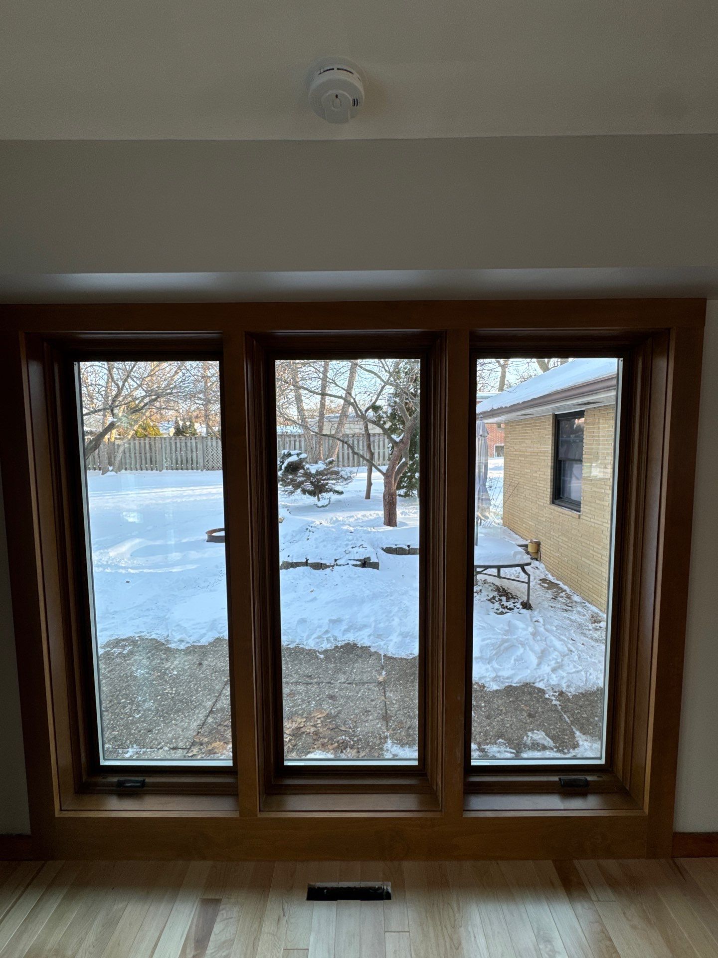 Black-Frame Pella Lifestyle Upgrade on a Partial Brick Home by United Windows and Siding LLC