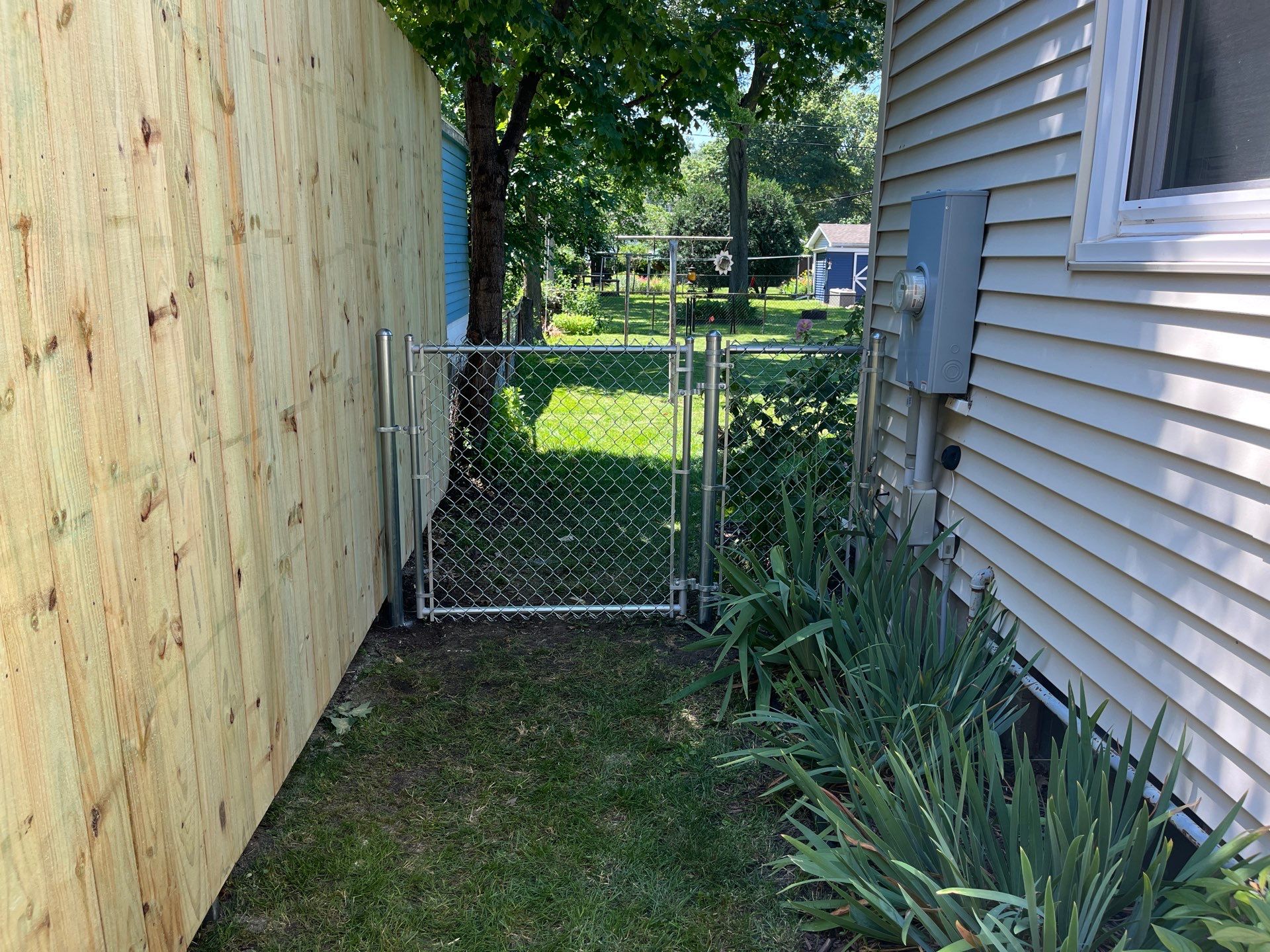 Pressure-Treated Wood Privacy Fence Installation in Cedar Falls by Perfect Picket Fence and Stain