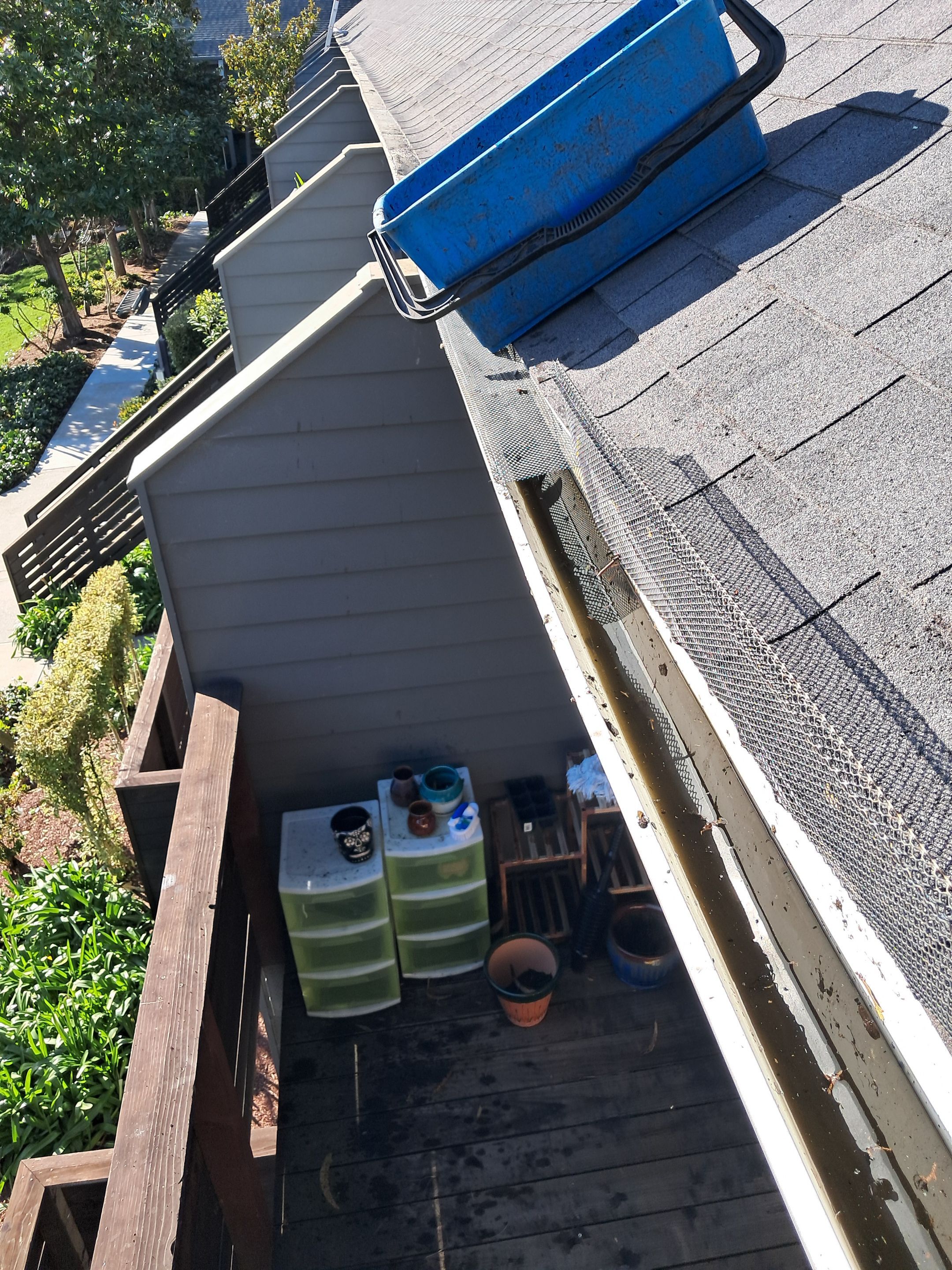 HOA gutter cleaning in Santa Cruz, after  photo showing full gutters.