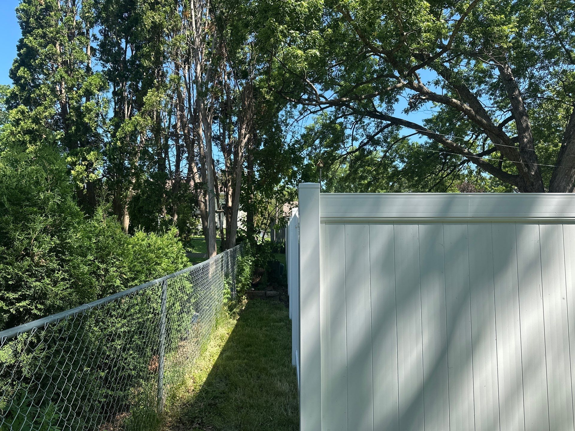 White Vinyl Privacy Fence and Double Gate Installation in Cedar Falls by Perfect Picket Fence and Stain