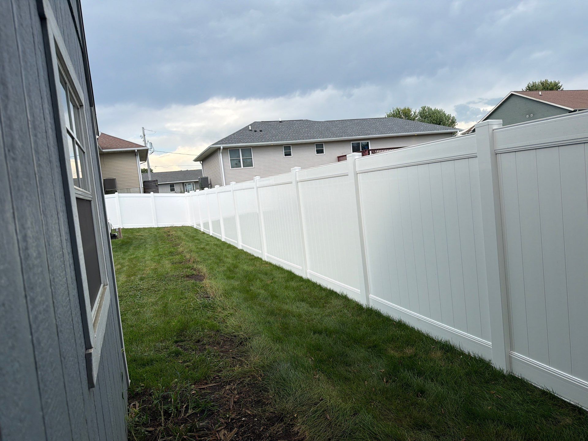 White Vinyl Privacy Fence Installation in Raymond, IA by Perfect Picket Fence and Stain