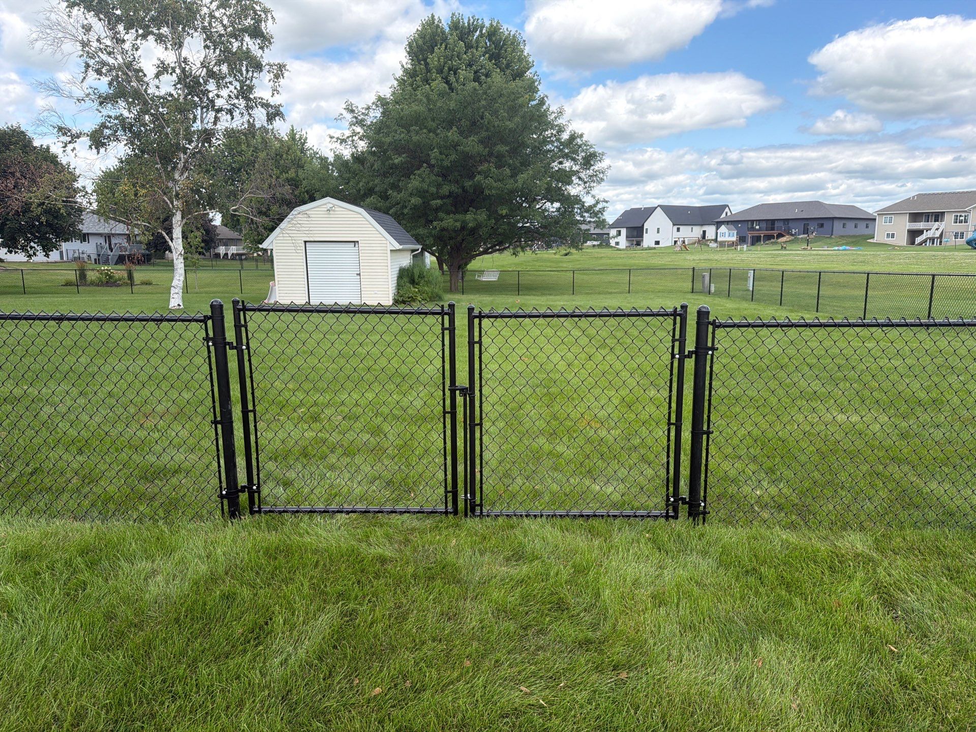 Black Vinyl-Coated Chain Link Fence Installation in Fairbank by Perfect Picket Fence and Stain