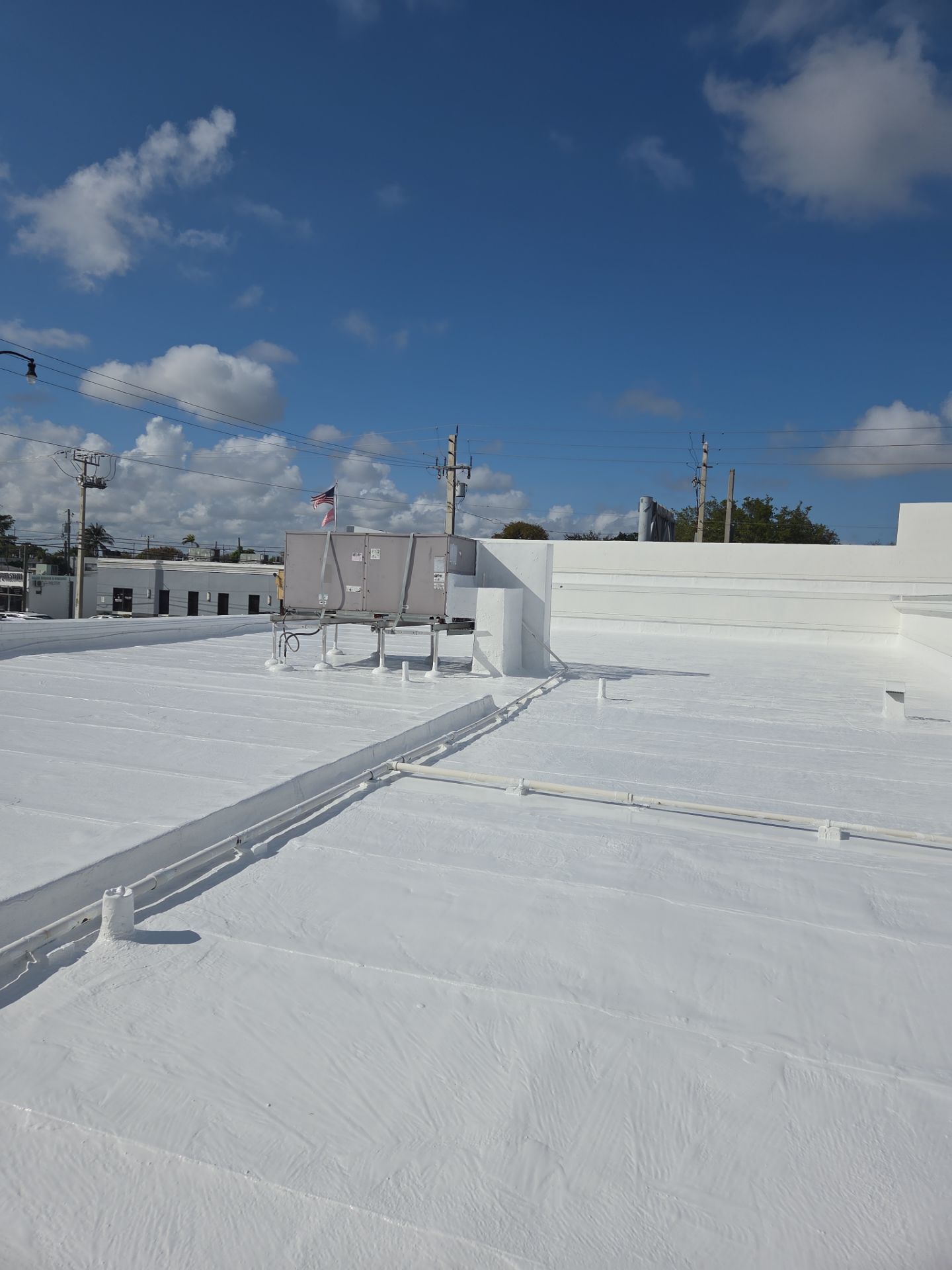 Commercial Flat Roof Restoration Using Silicone Coating in Hallandale Beach by Aastro Roofing
