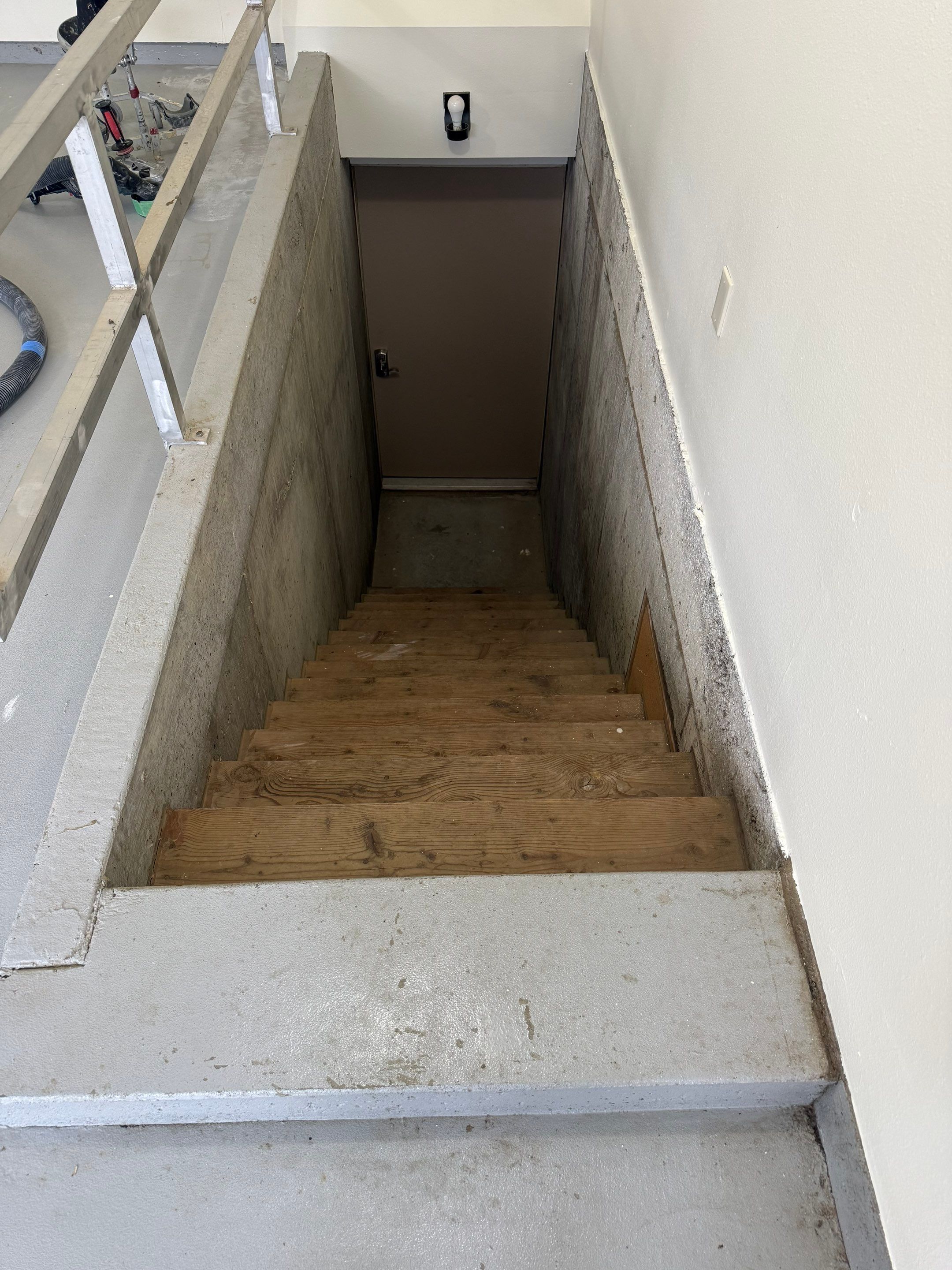 Custom Polyaspartic Garage Floor and Stairwell Coating in Pipestone by Select Painting, Coatings & Garage Cabinets