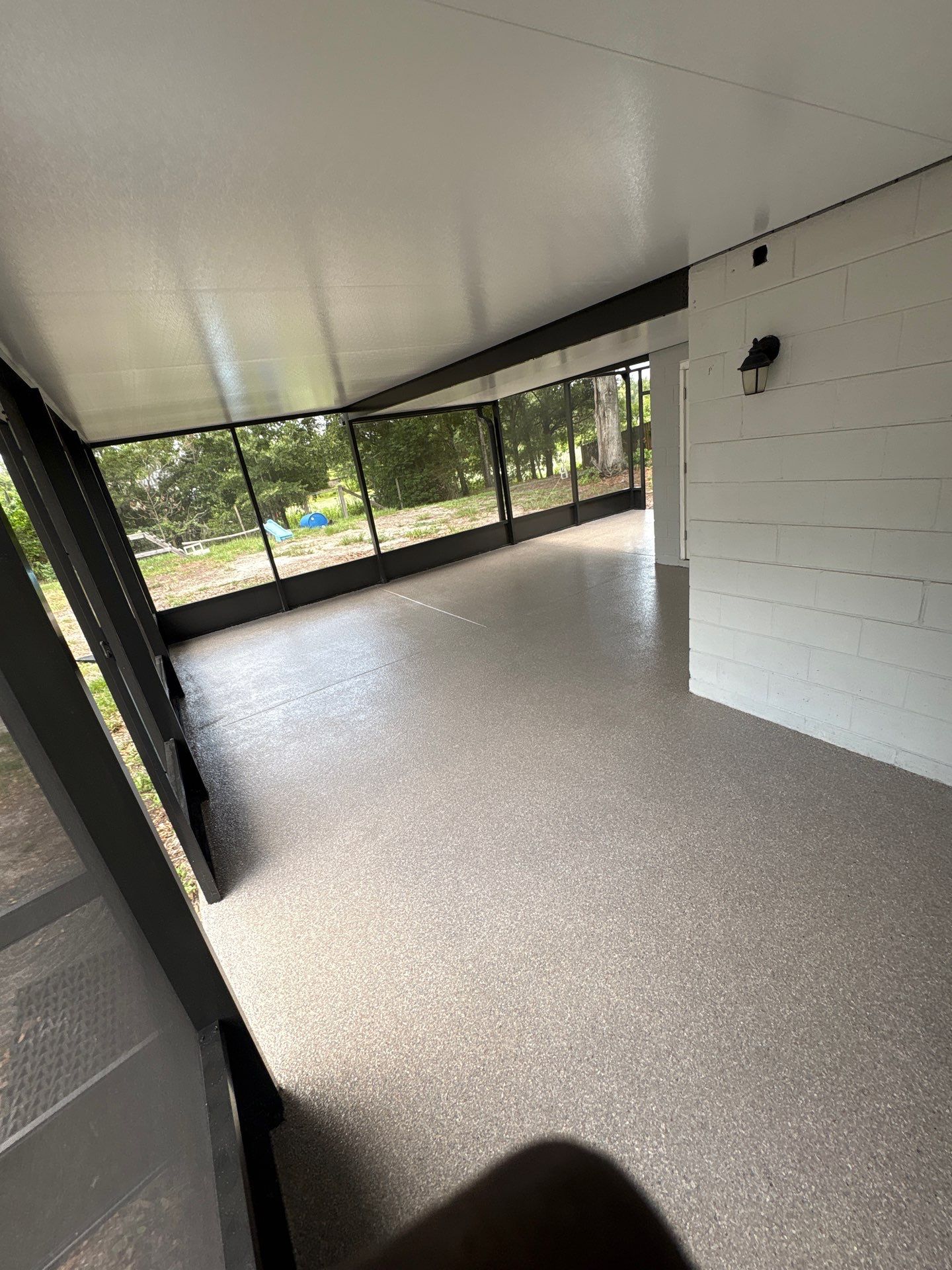 Screened-in Lanai Polyaspartic Floor Coating Installation in Riverview by Performance Floors & Coating