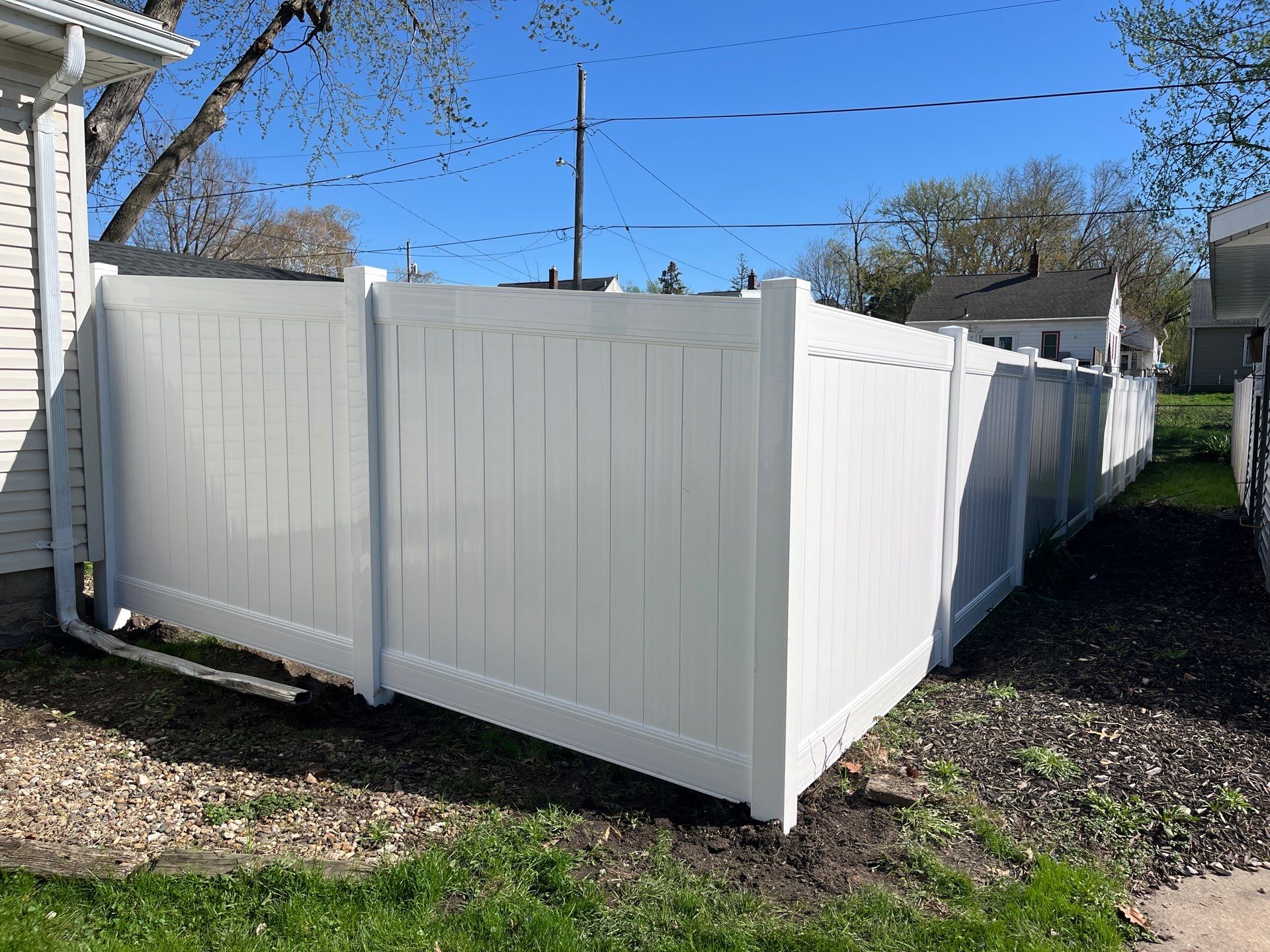 Residential White Vinyl Privacy Fence Installation in Waterloo, Iowa by Perfect Picket Fence and Stain
