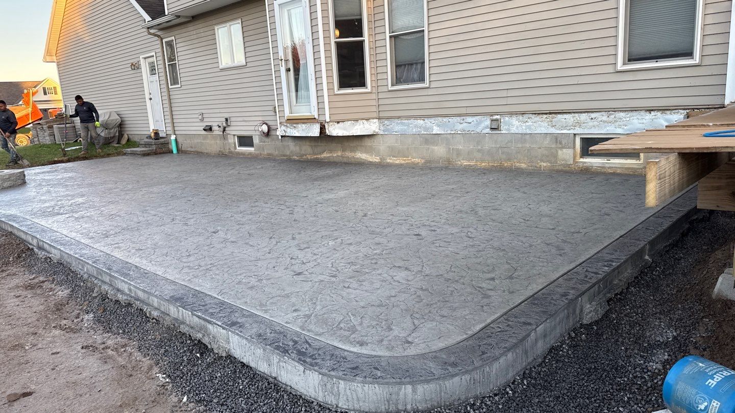 Oxford slate stamped concrete patio  by NG Masonry & Construction LLC