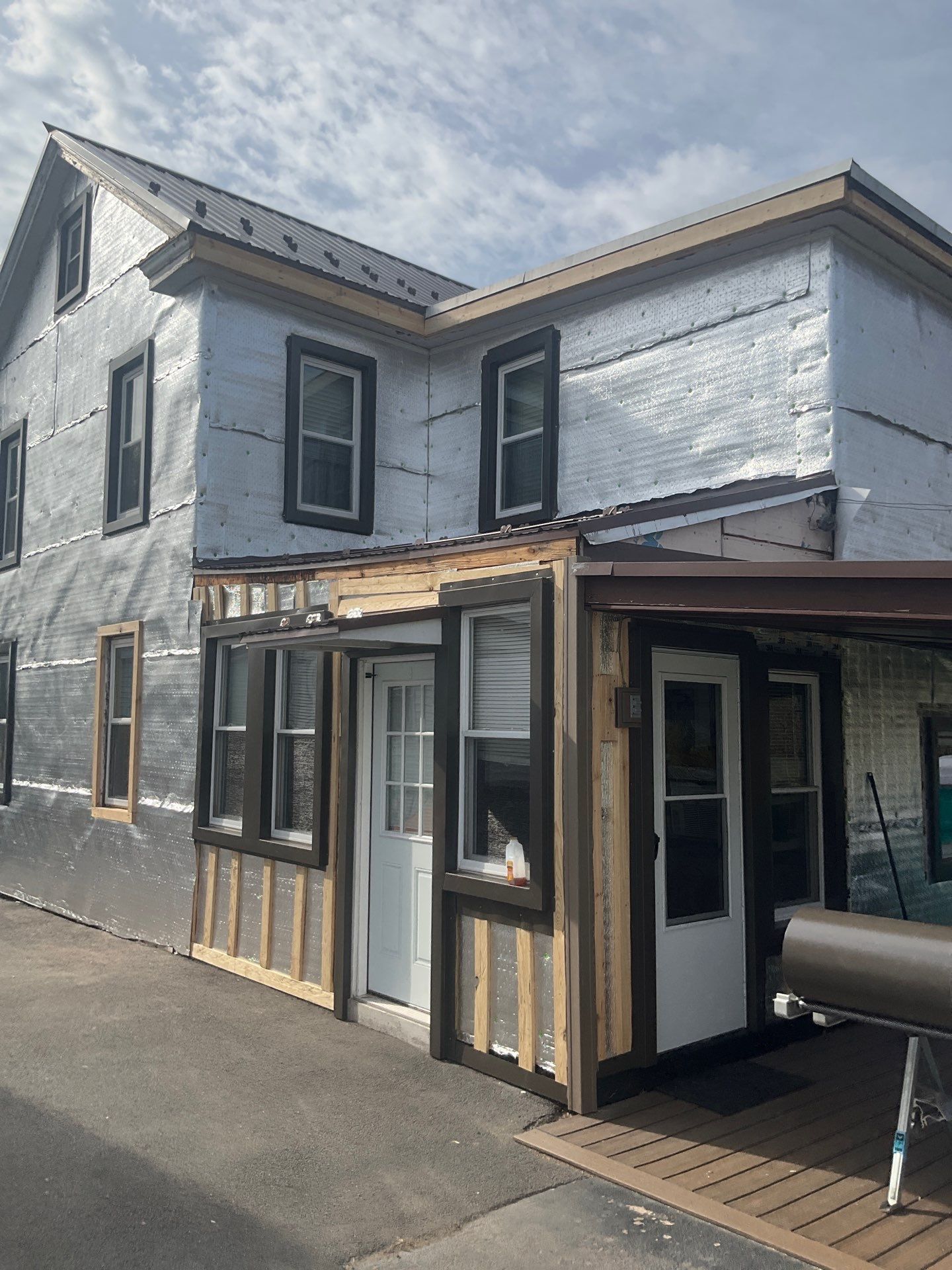 Exterior Renovation with Vinyl Siding, Metal Roof & Spouting  by Esh Builders