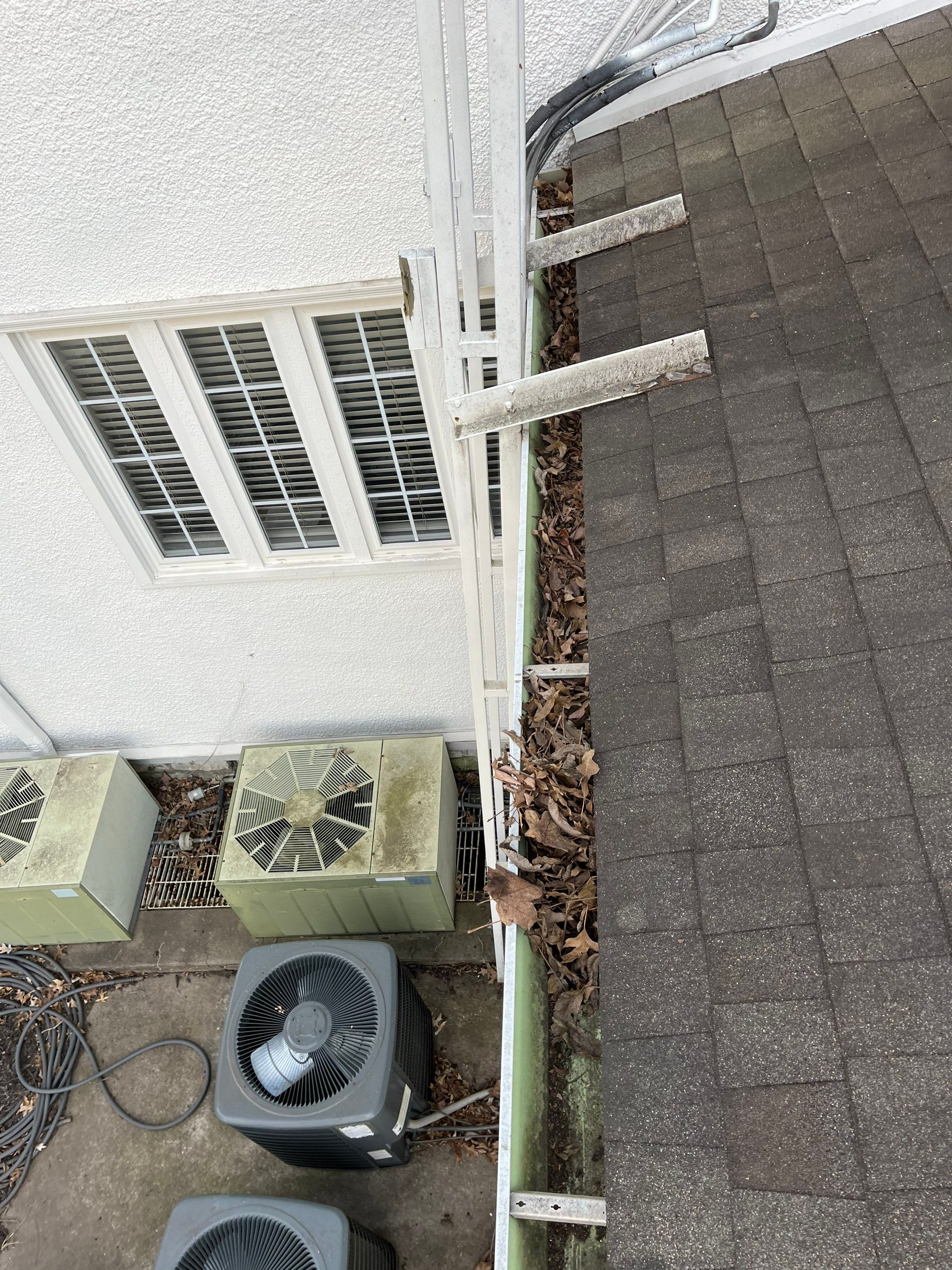 Commercial gutter cleaning Kansas City before photo with filled gutters