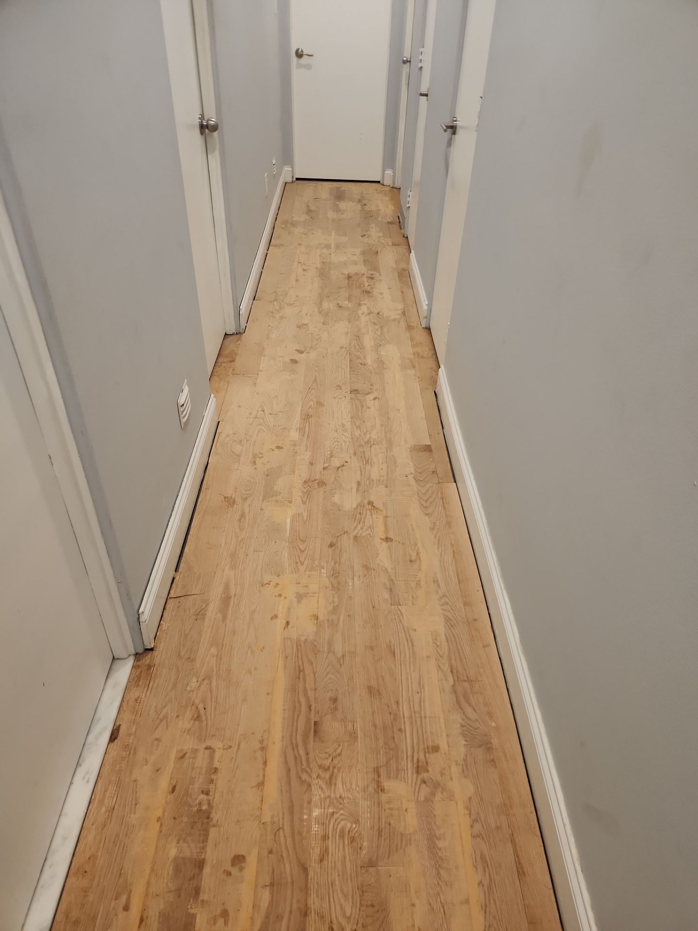 New Flooring installation using 4" White oak select grade plain sawn Ebony Stain by Ann Arbor Hardwoods