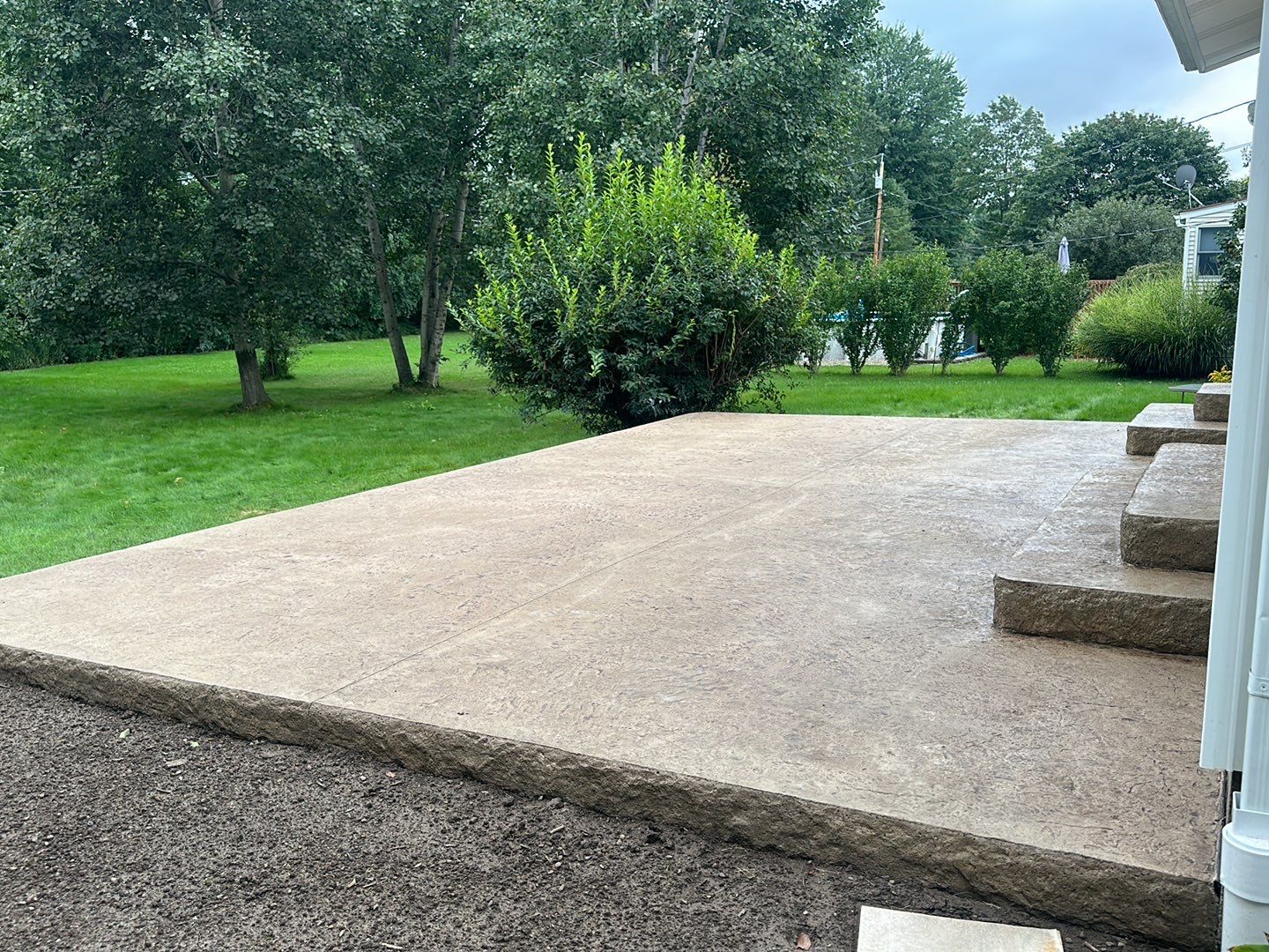Bluestone textured stamped concrete patio by NG Masonry & Construction LLC