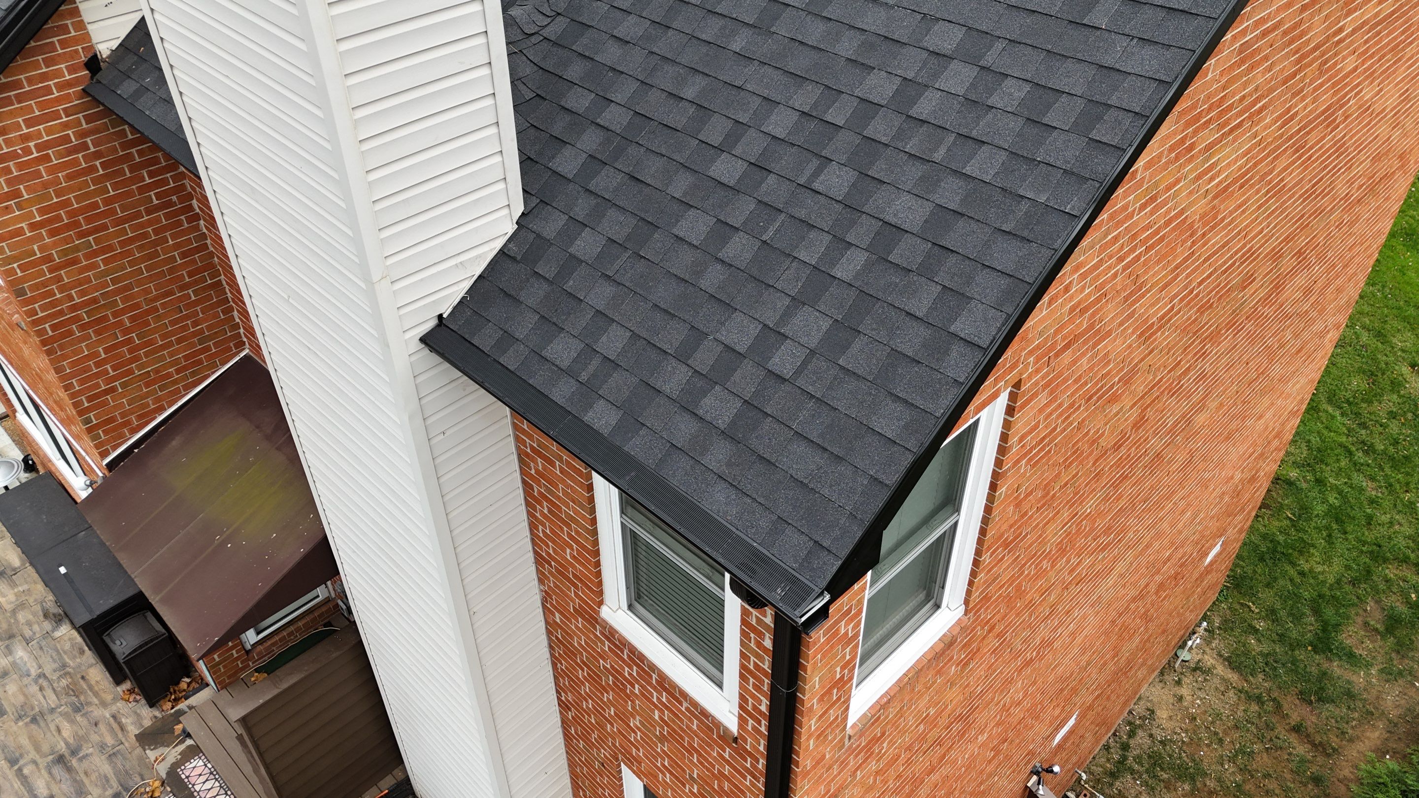 Charcoal Black Re-Roof & Gutters by Royal House LLC