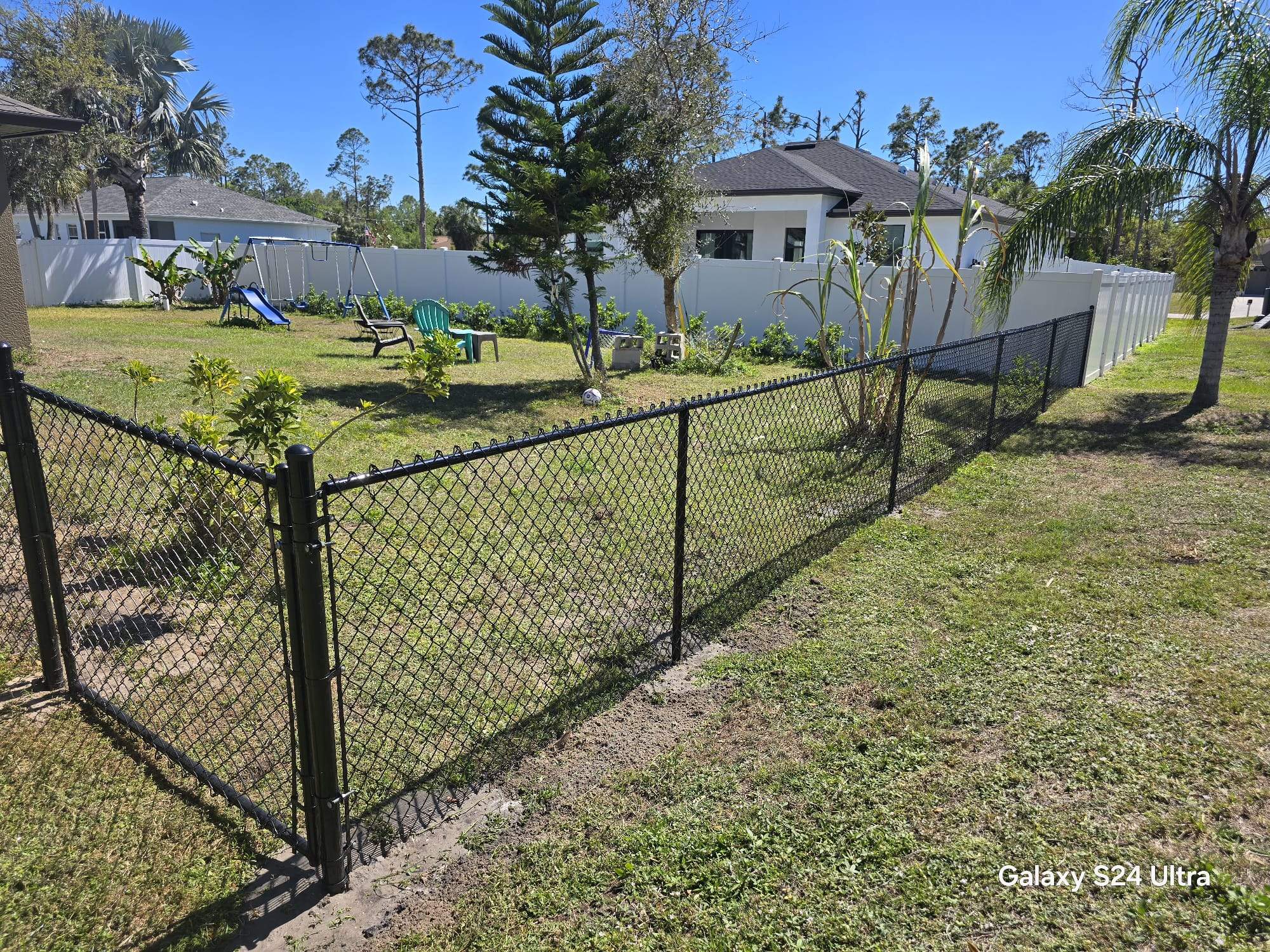 Residential Black Vinyl-Coated Chain Link Fence Installation in North Port by True Fence LLC