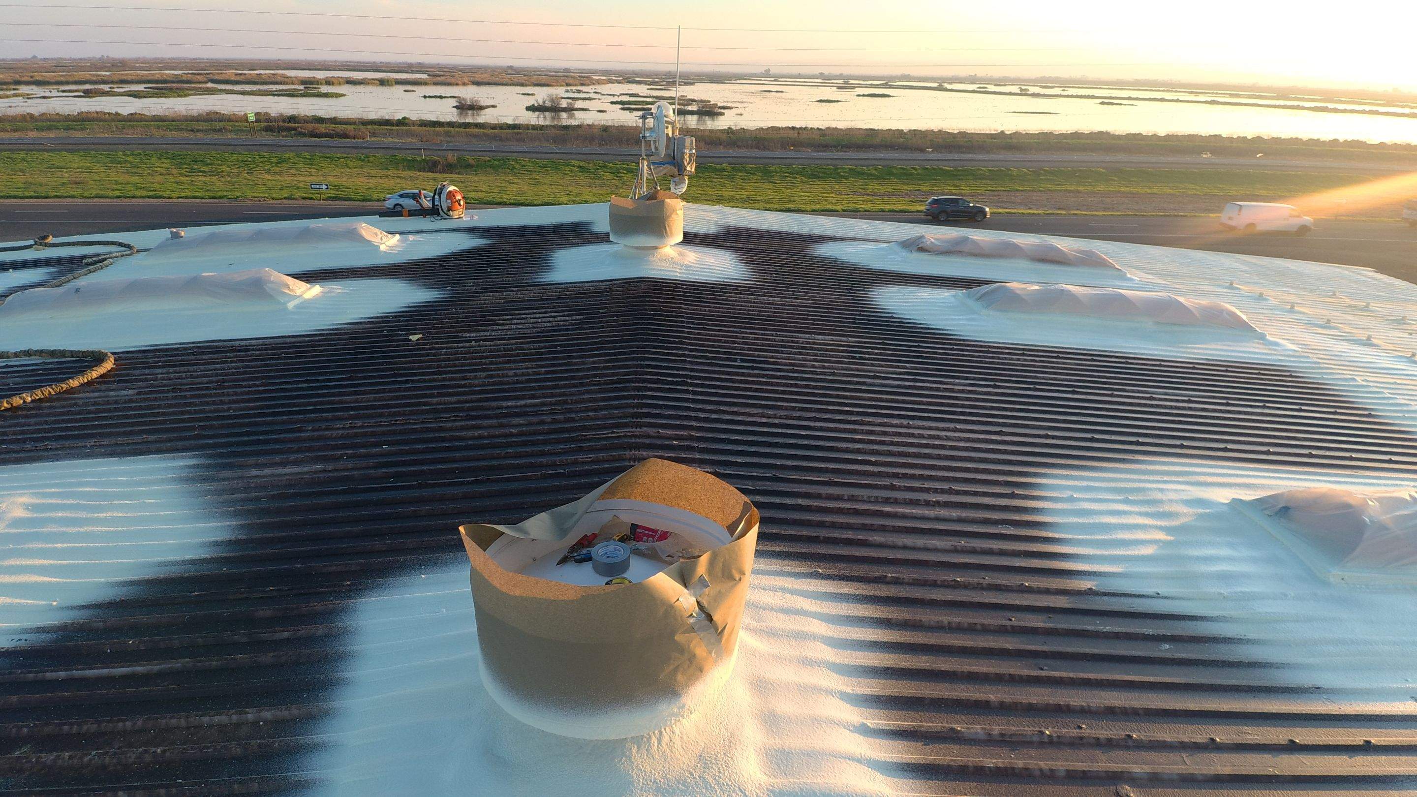 Metal roof restoration on commercial roof using Conklin Benchmark/ PUMA XL acrylic coatings over metal and foam by Straight Edge Roofing Inc