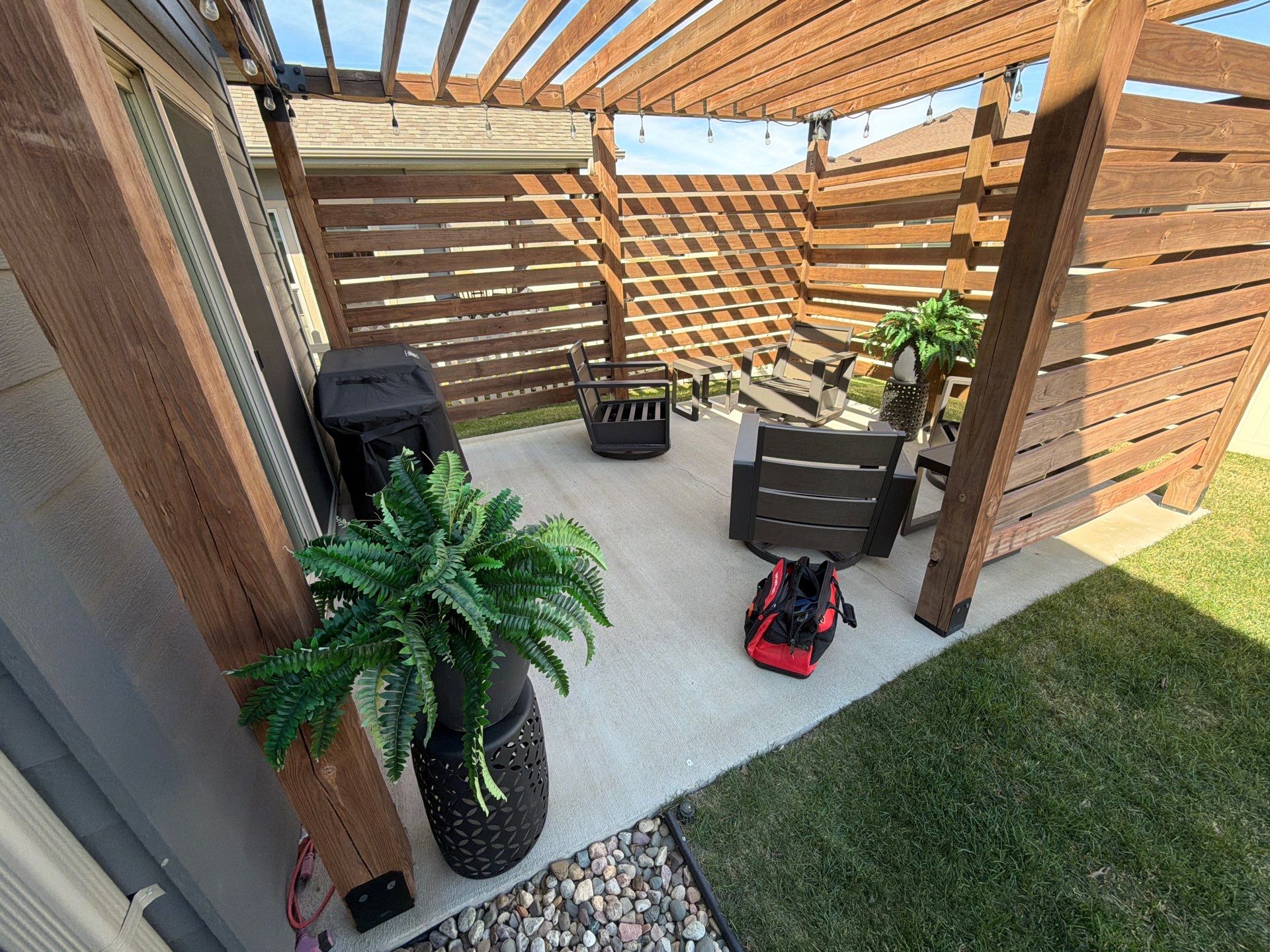 Textured Concrete Patio Coating and Custom Privacy Pergola in Sioux Falls by Select Painting, Coatings & Garage Cabinets